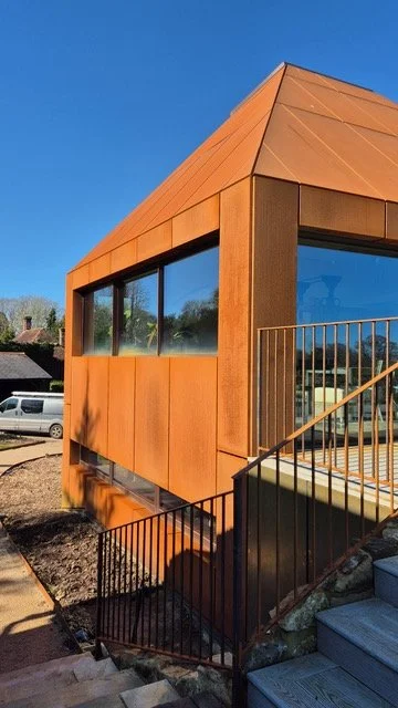 Close view of Corten steel wall cladding, corner details and a horizontal window.