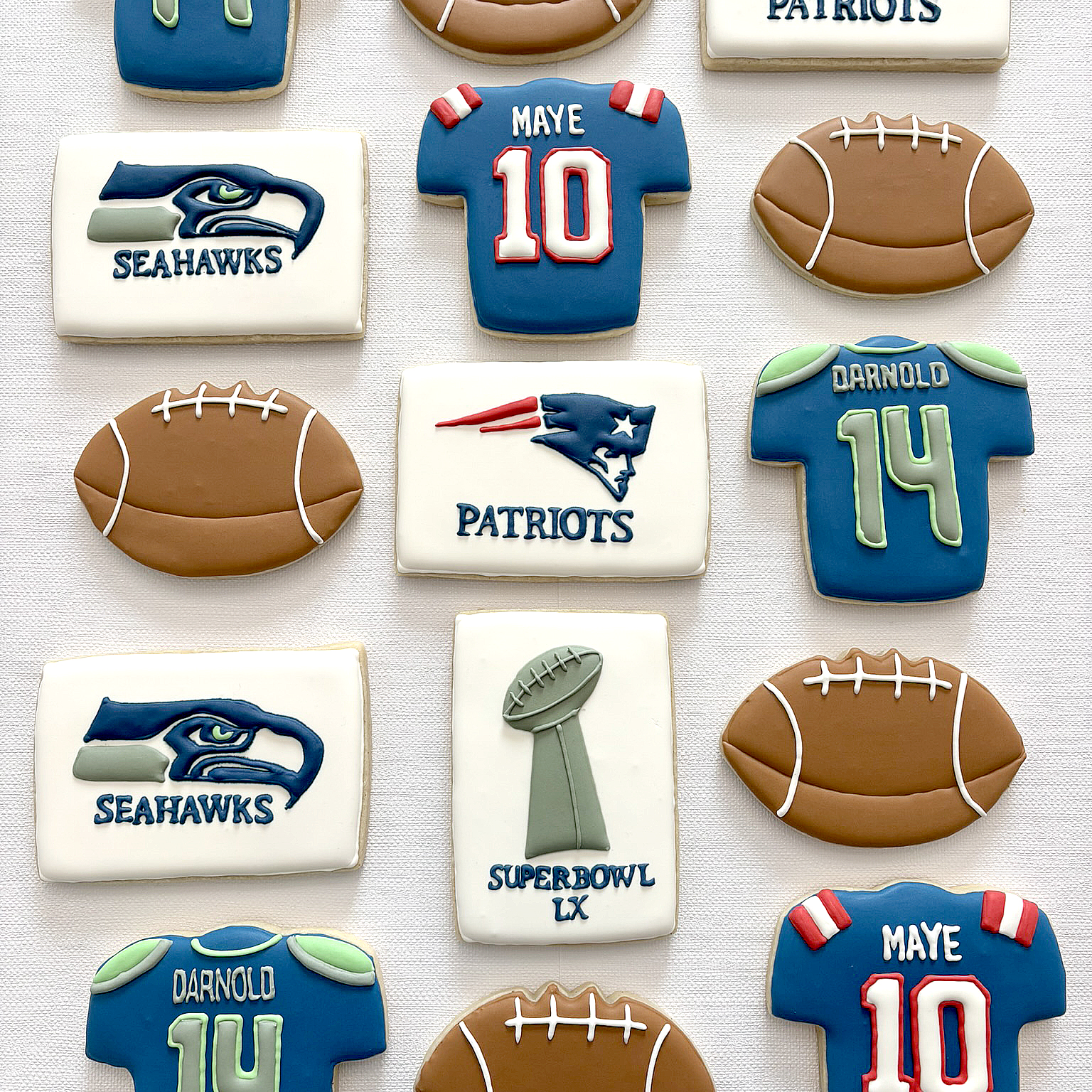 Collection of custom decorated cookies featuring football themes.