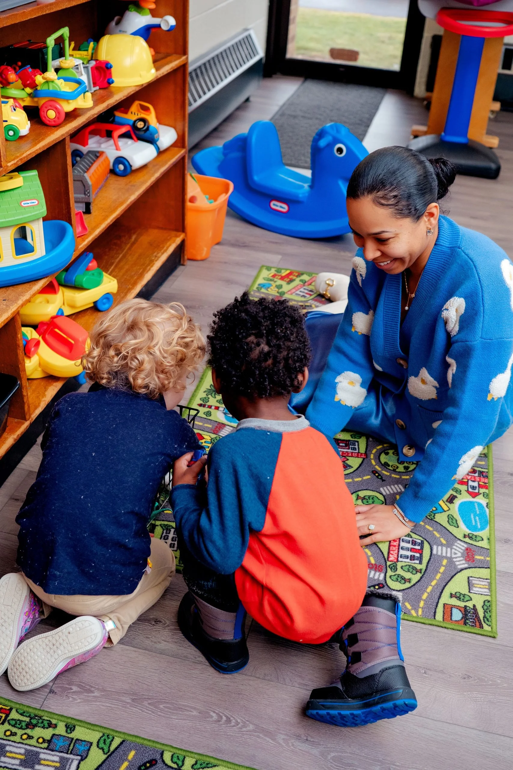 KIds playing on a mat in preschool