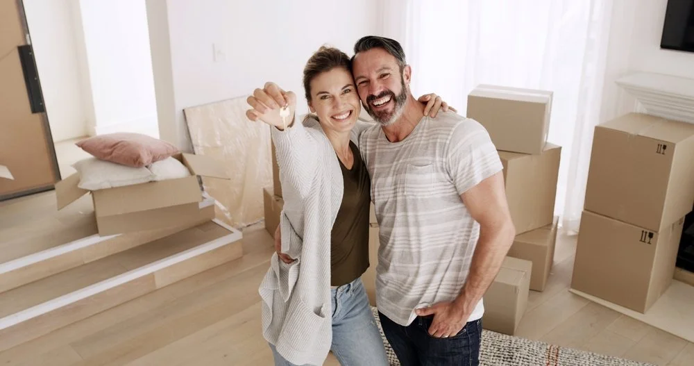Happy couple after buying a home in White Plains New York with guidance from a real estate attorney
