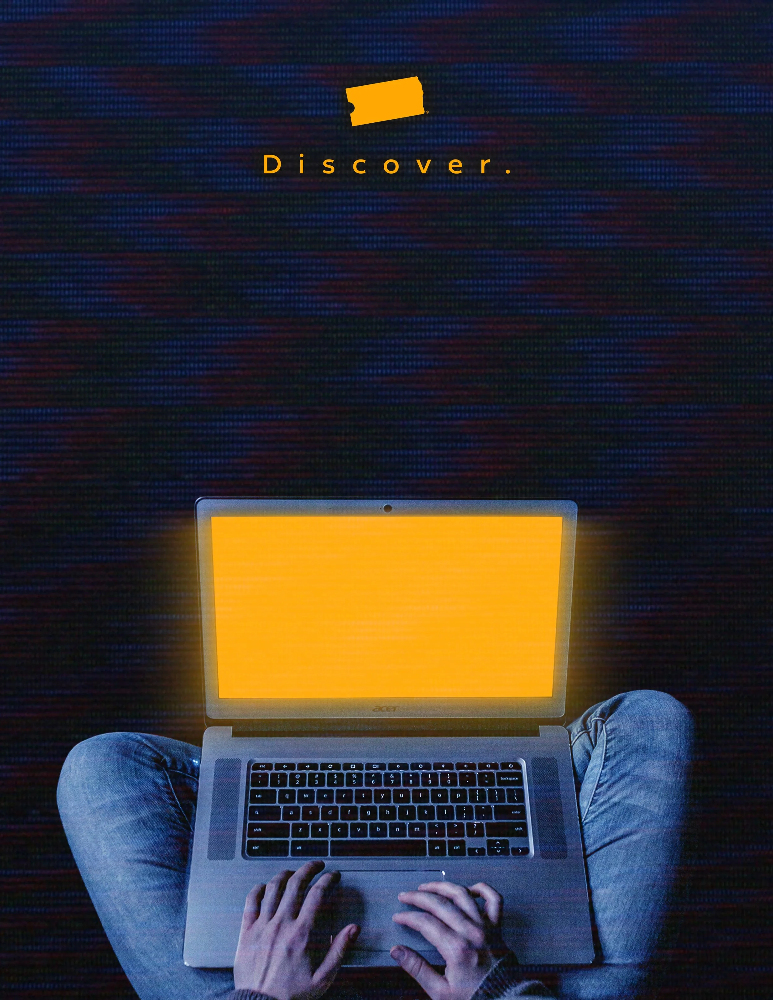 Person with a laptop showing a bright yellow light in a dark room