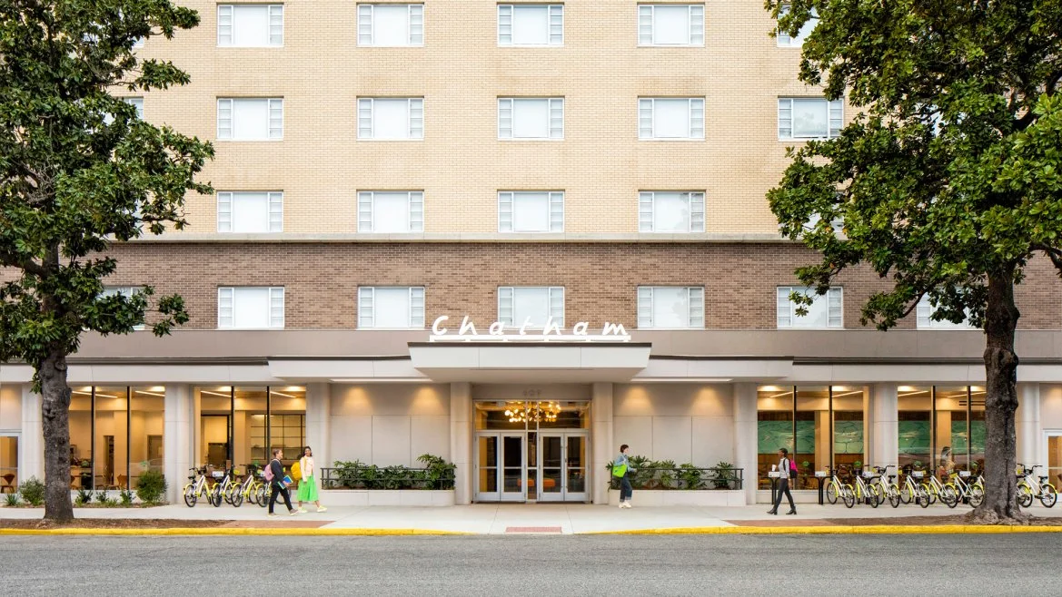 Exterior view of the Chatham hotel with people walking past bicycles parked outside.