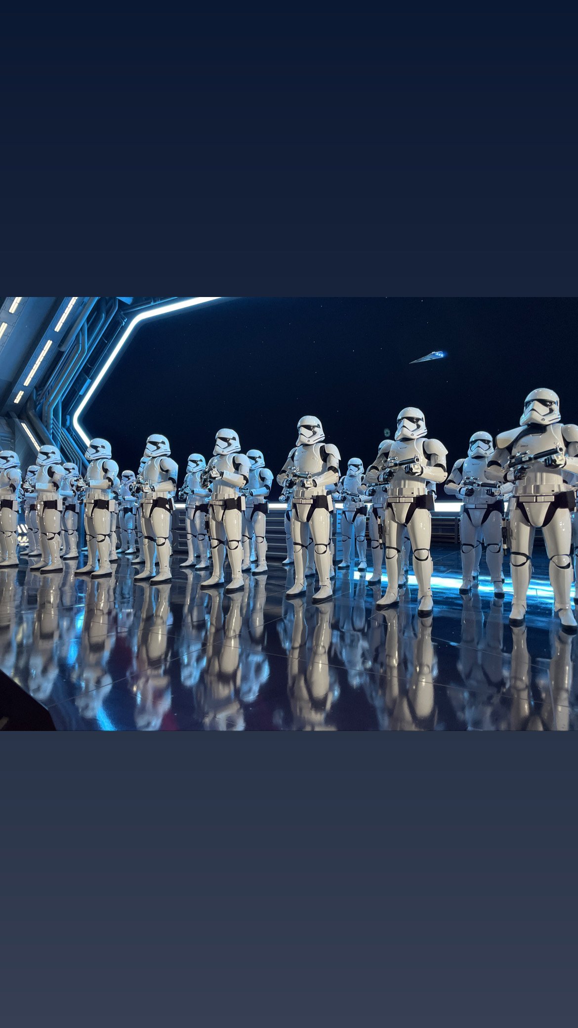A lineup of Star Wars Stormtrooper figures in a futuristic setting with blue lighting and technological elements.