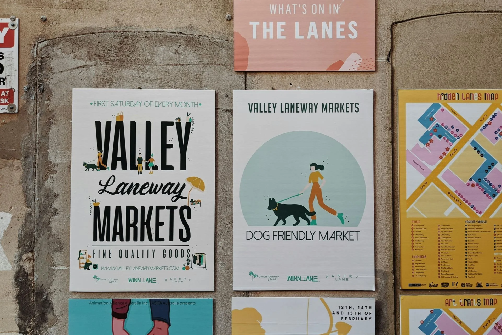 Posters advertising Valley Laneway Markets, Dog Friendly Market, and a map of the lanes with various listings.