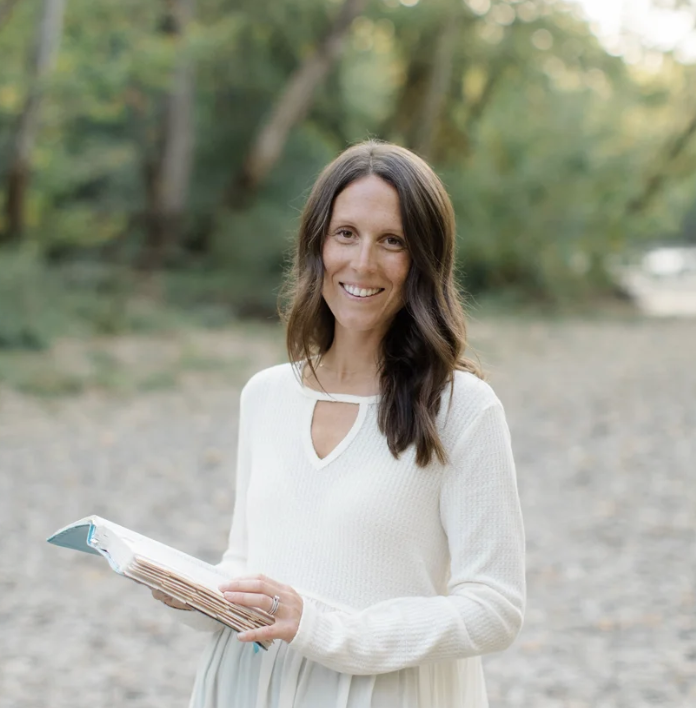 Author Chelsey DeMatteis holding a book