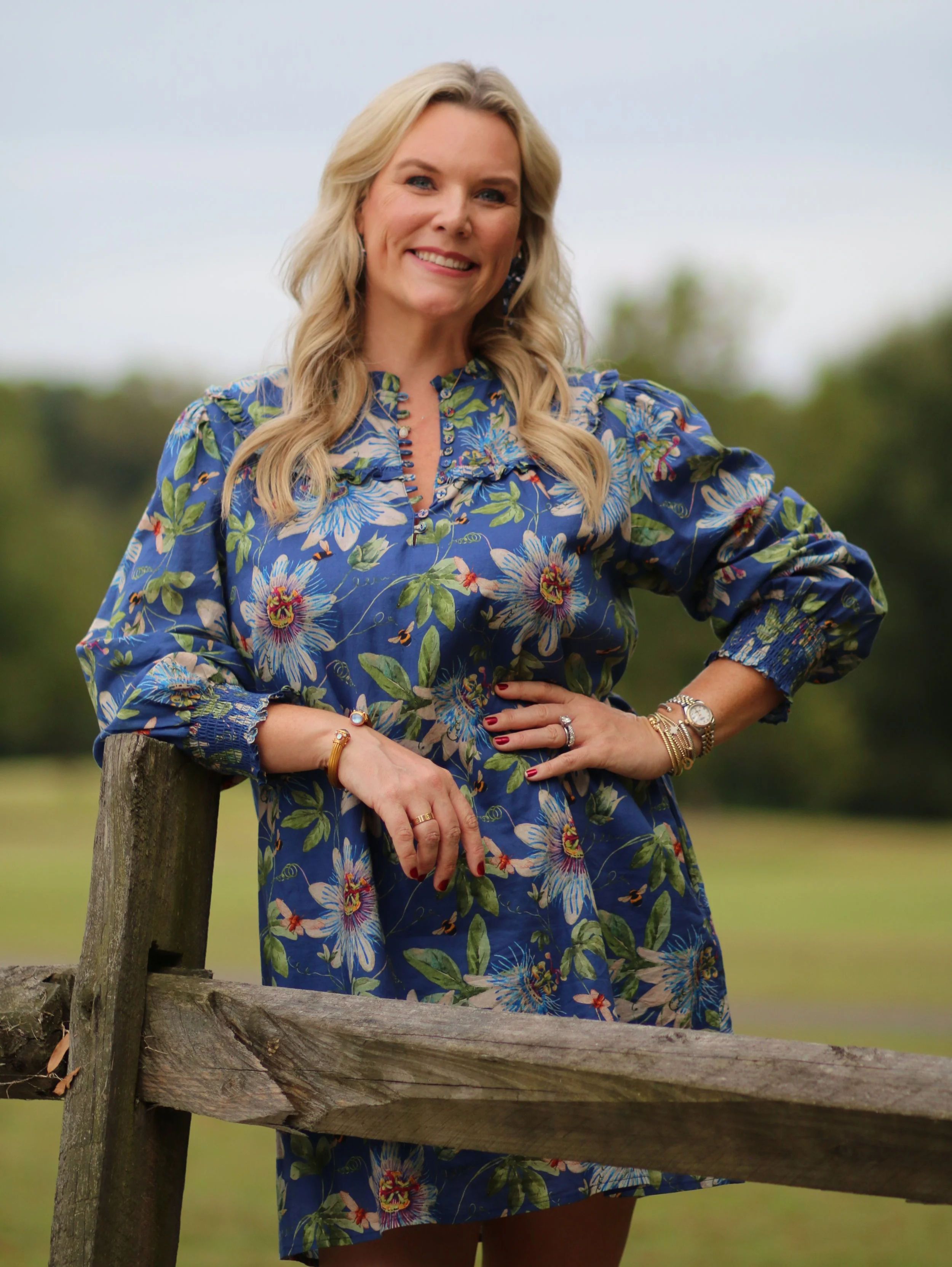 Interior designer Stephanie of Visceral by Design in High Point NC, wearing a blue floral dress outdoors