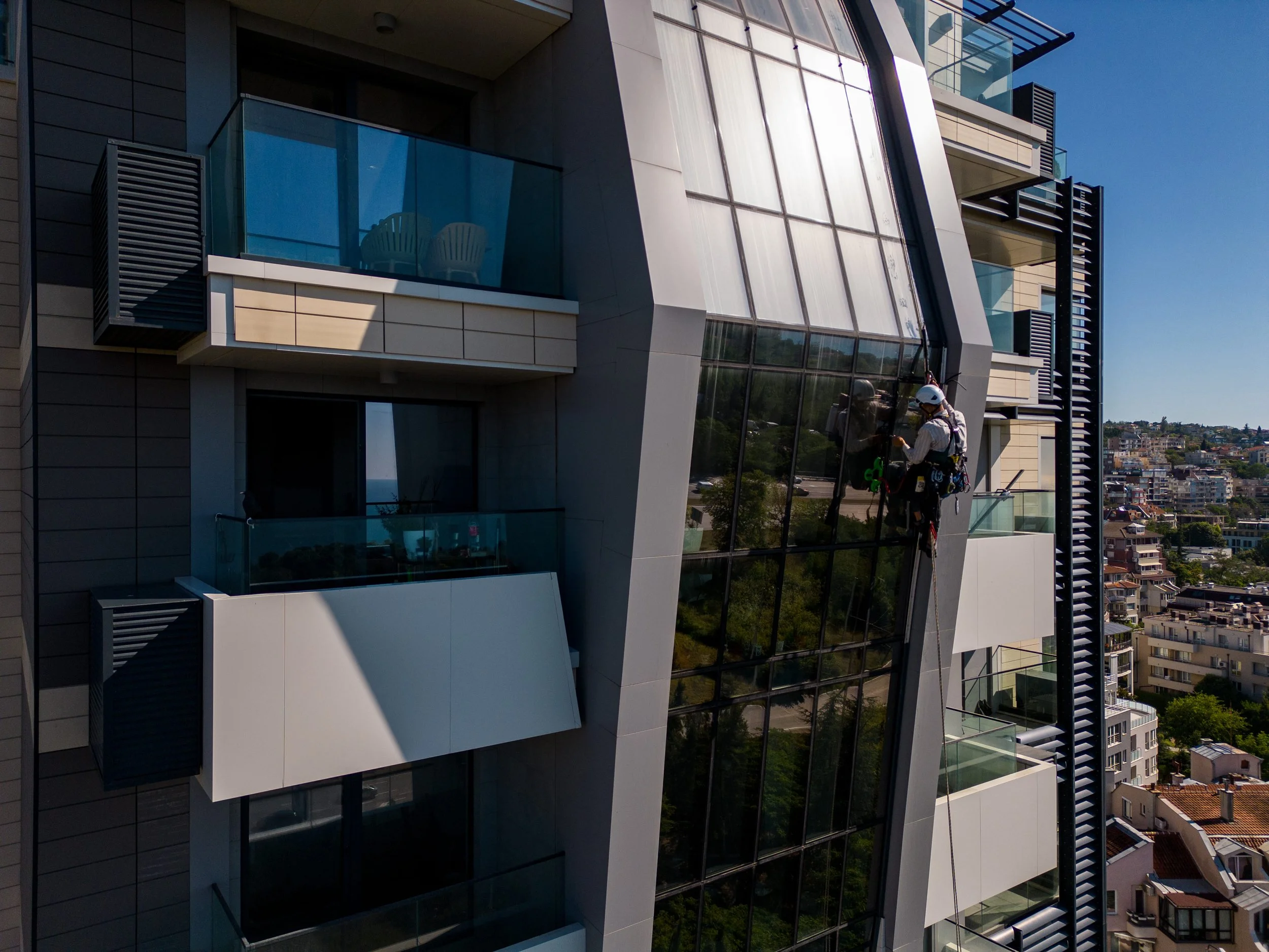 industrial-climber-performs-tasks-great-height-glass-wall-tall-building-drone-video.jpg