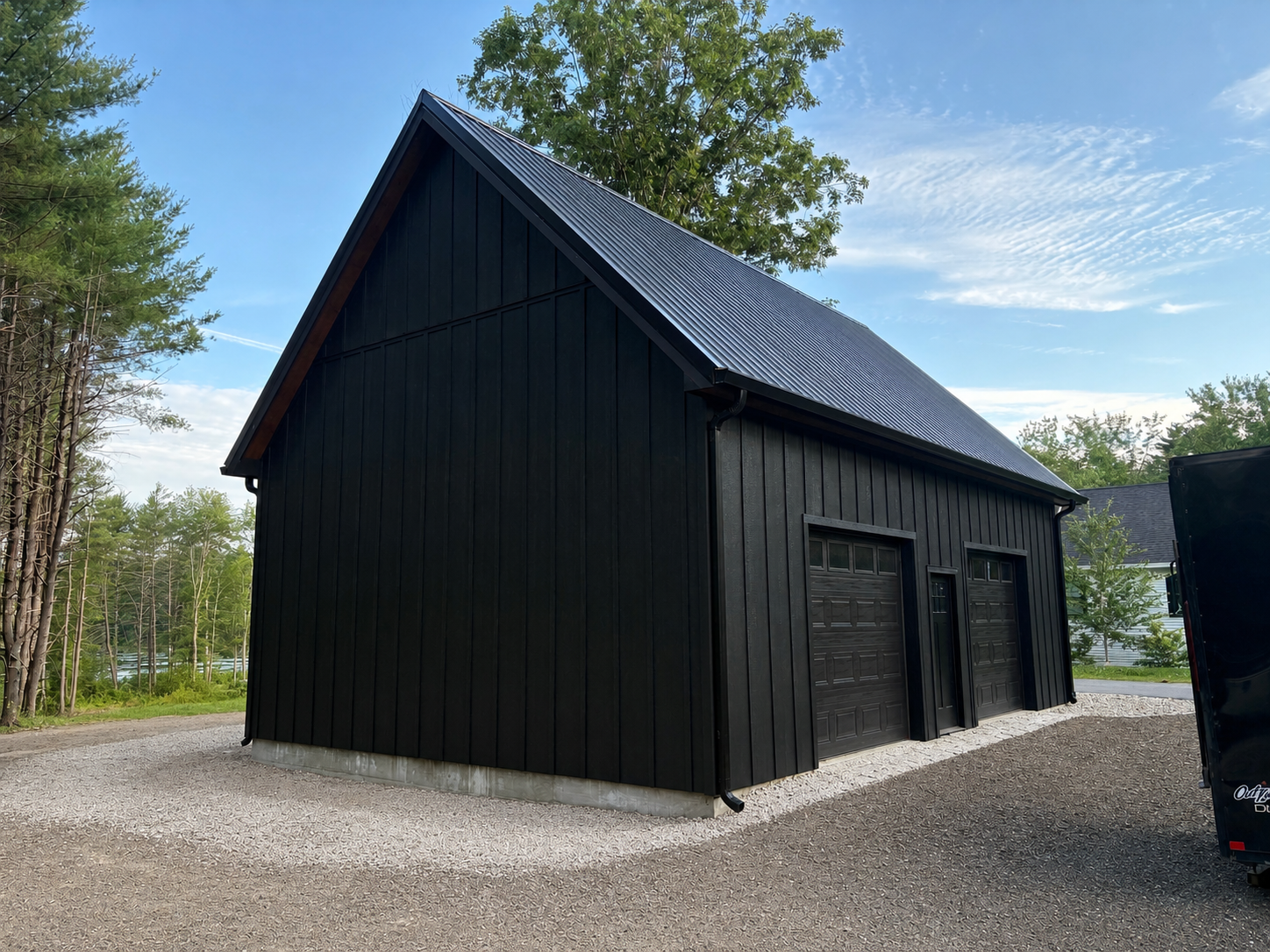 A simple vision brought to life with timeless black board & batten siding and a standing seam metal roof.