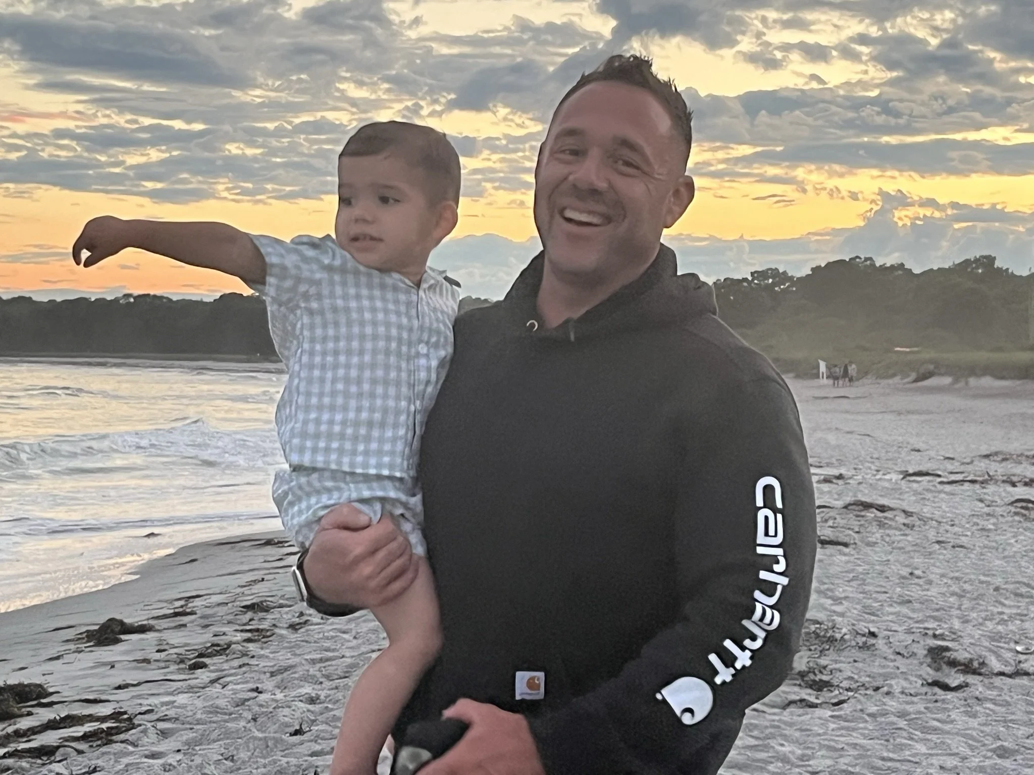 Owner of Black Barn Contracting, Ryan Crowley, holding his son