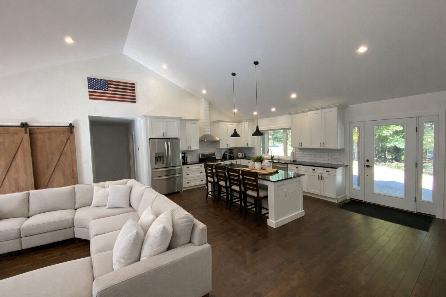 Custom Kitchen and Living Room with Barn Door Pantry and Open Floorplan