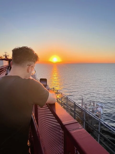 Virgin Voyages cruise ship at sea during sunset