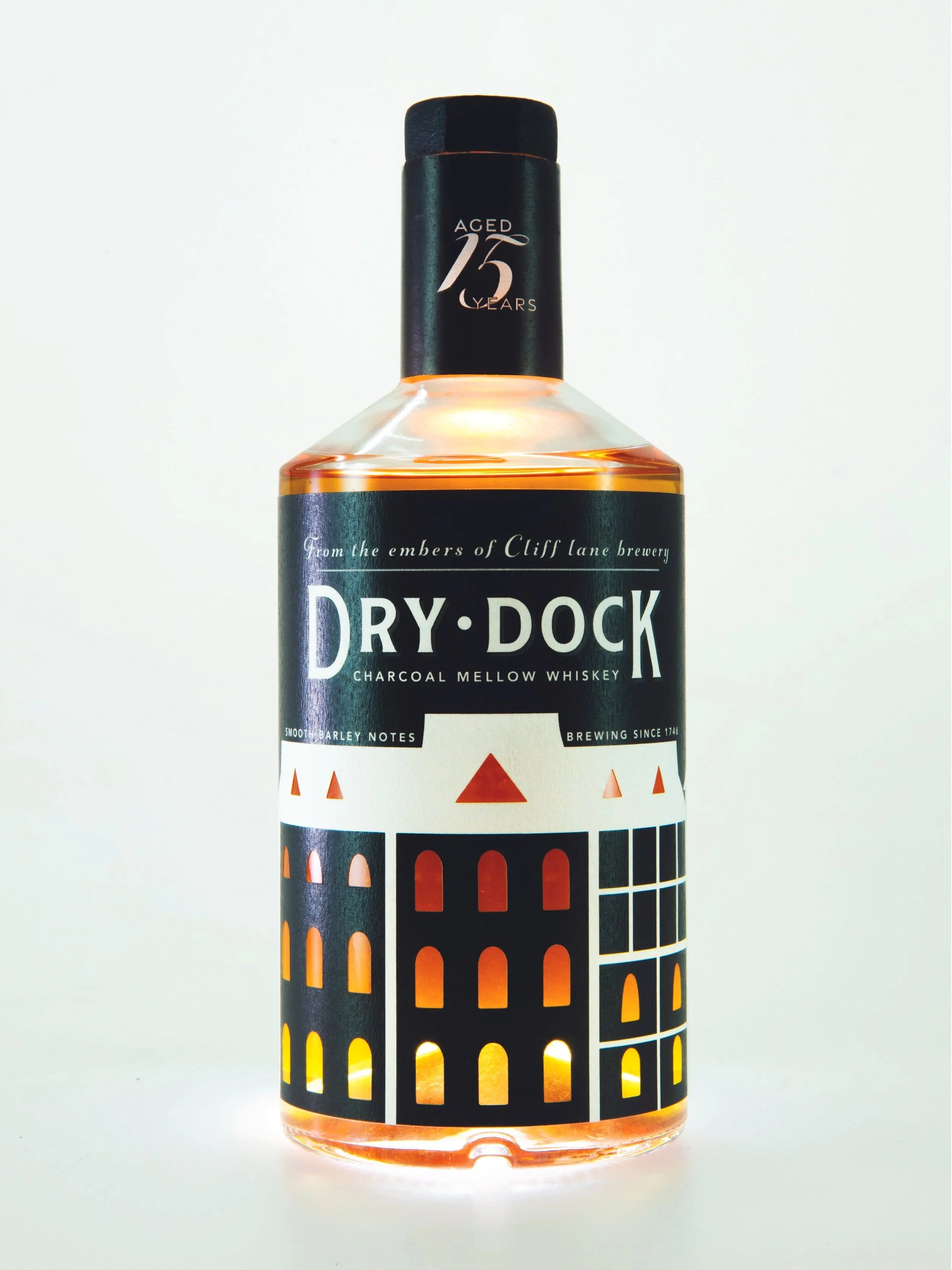 Bottle of Dry Dock Charcoal Mellow Whiskey with a black lab-inspired label design