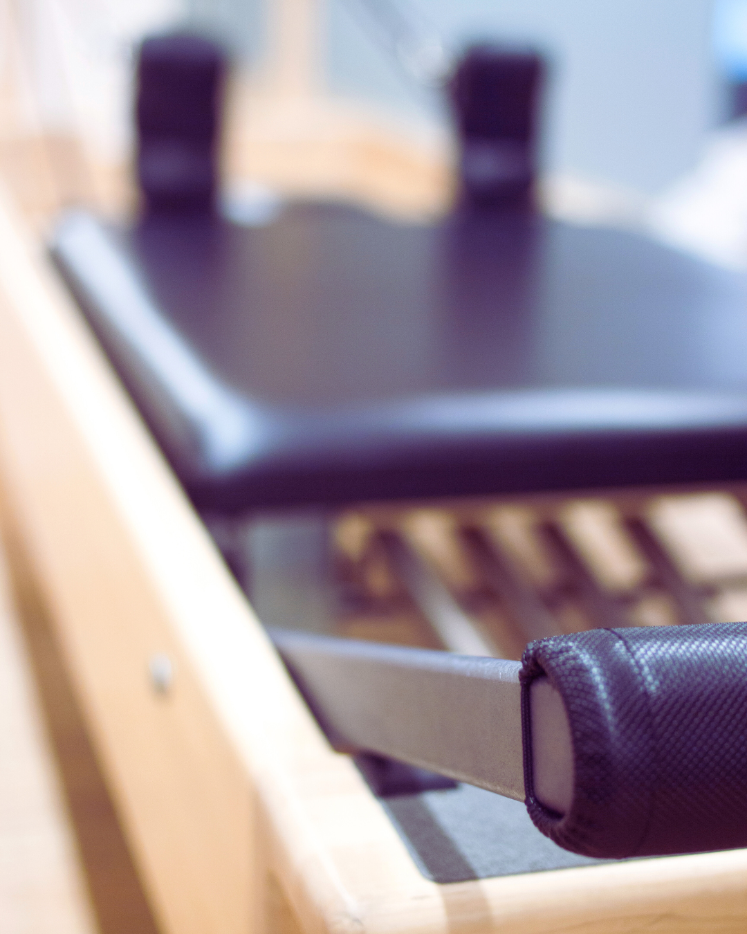 Close-up of a shuffleboard table with pucks, out of focus, in a recreational room.