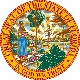 The Great Seal of the State of Florida showing a Seminole woman planting a Cuban lantana, with a steamboat in the background, a sun, and a Native American hunter with a spear, surrounded by the words 'Great Seal of the State of Florida' and the motto 'In God We Trust.'