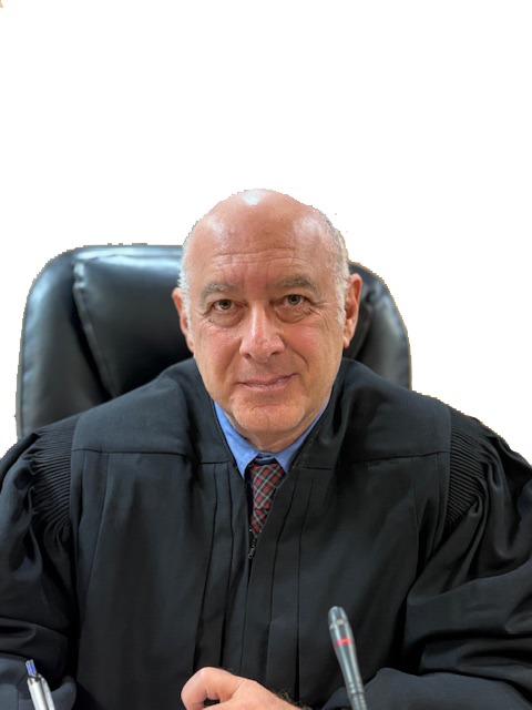Judge Robert Ostrov wearing a black robe sitting at a desk in a courtroom.