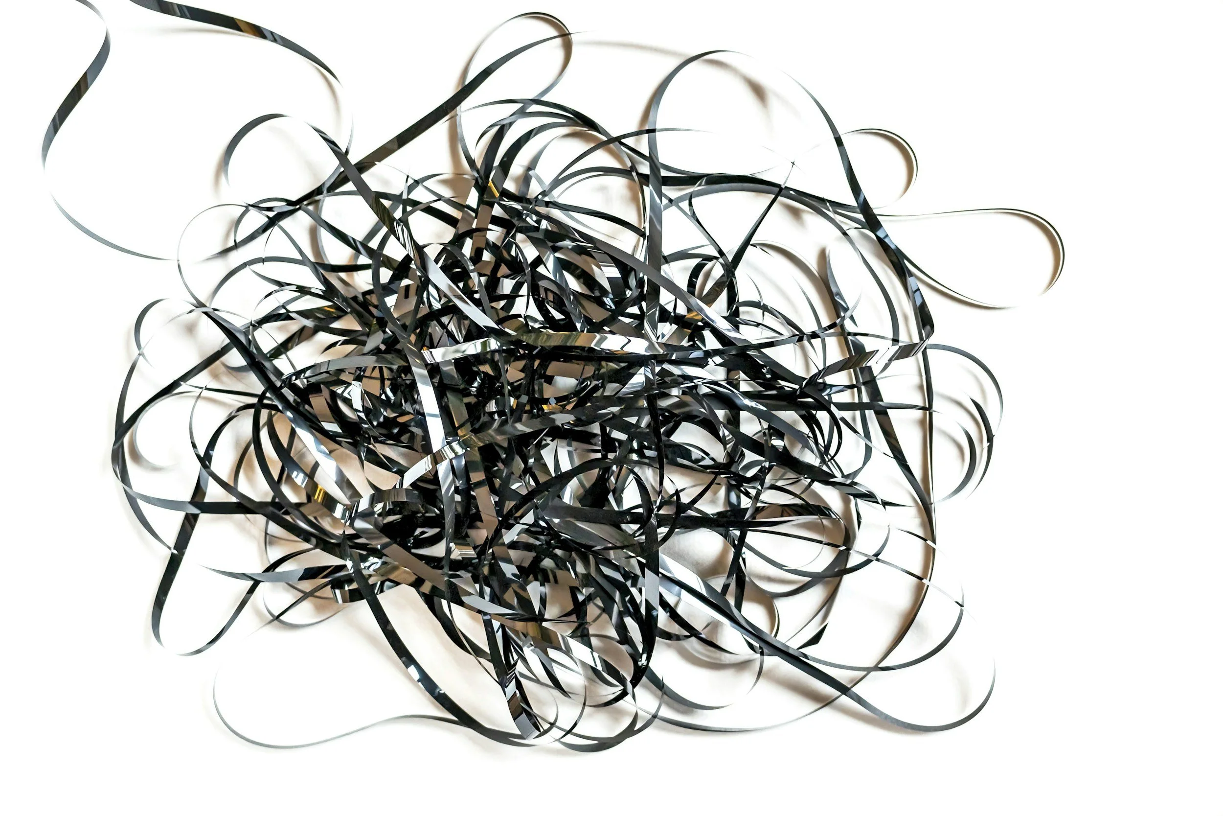 A chaotic mess of tangled audio tape to illustrate the stress of being a one-person successful business owner