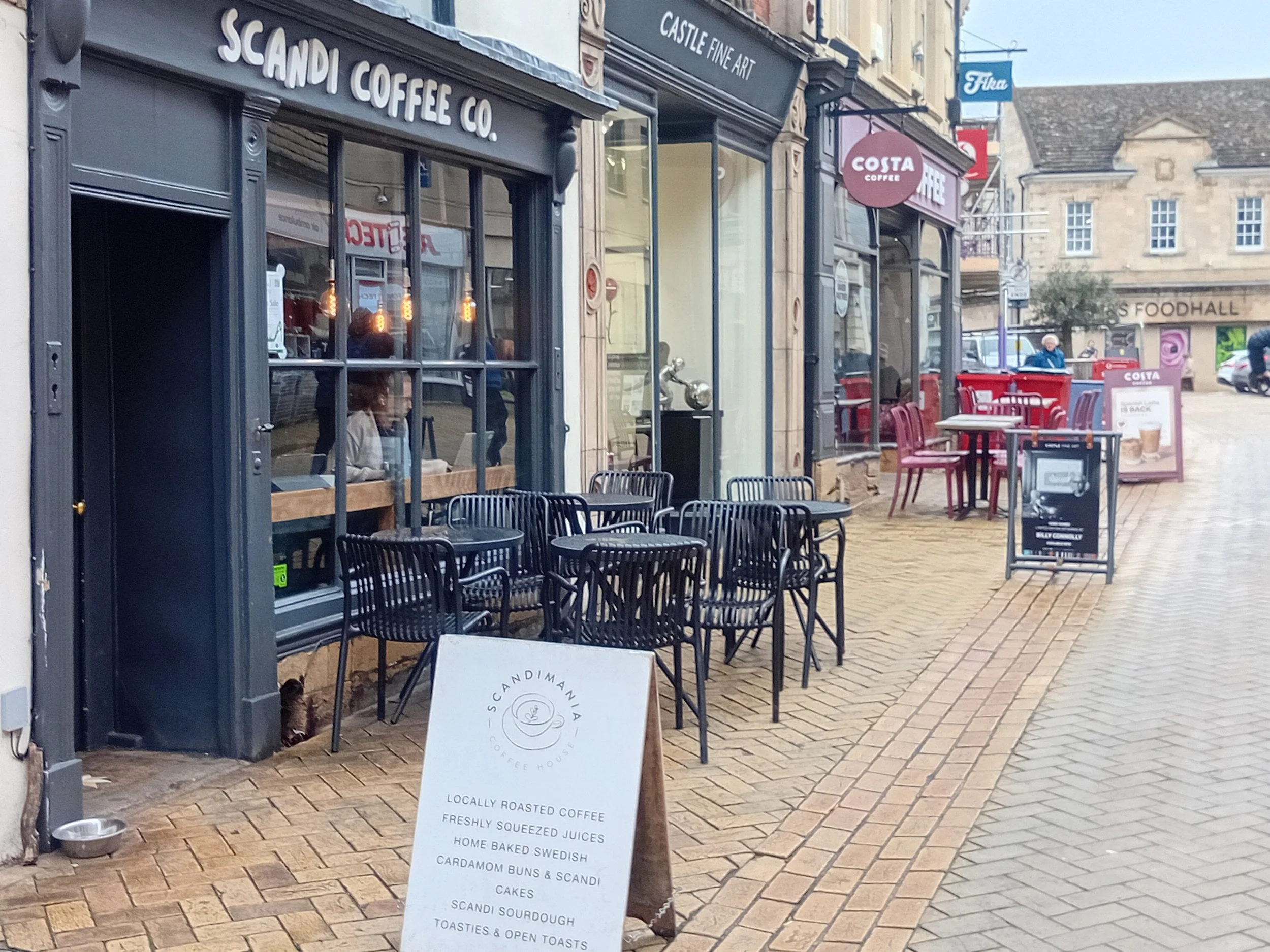 A image of coffee shops on High Street in Stamford: where you can meet your friends whilst I take care of your business for you.