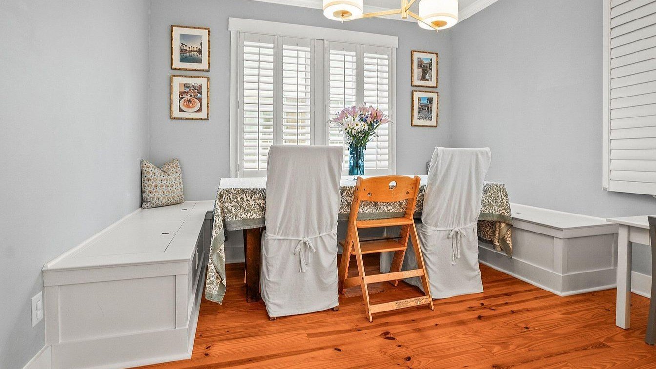 sturdy banquette adds tons of storage and extra seating in this dining room