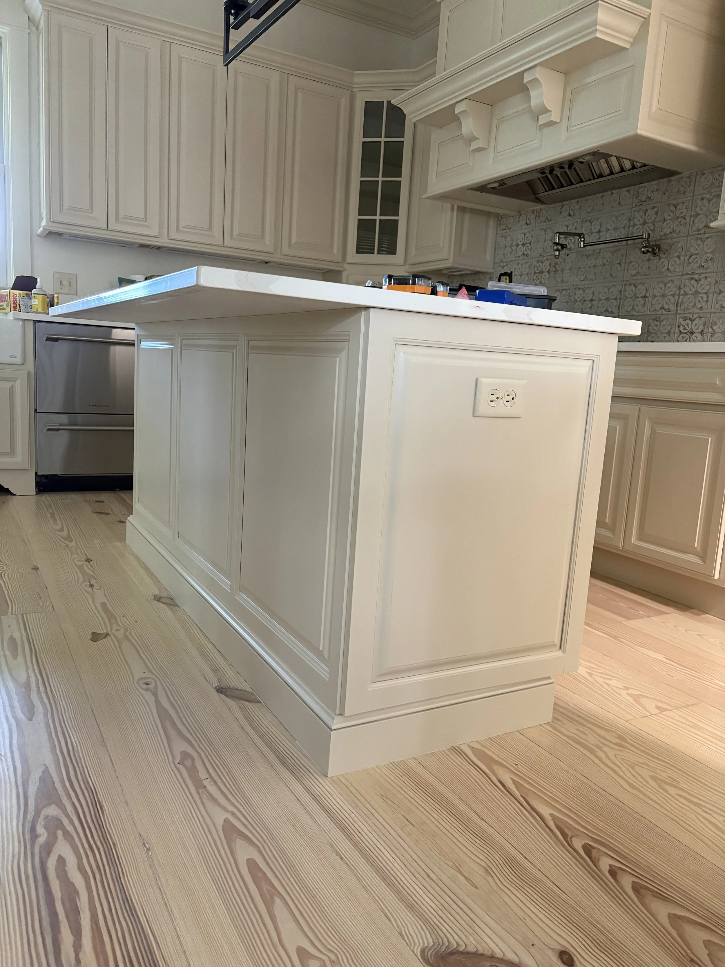 Replaced open shelving with raised panels to close in the ends of the island moved electrical and converted fixed panels to working doors