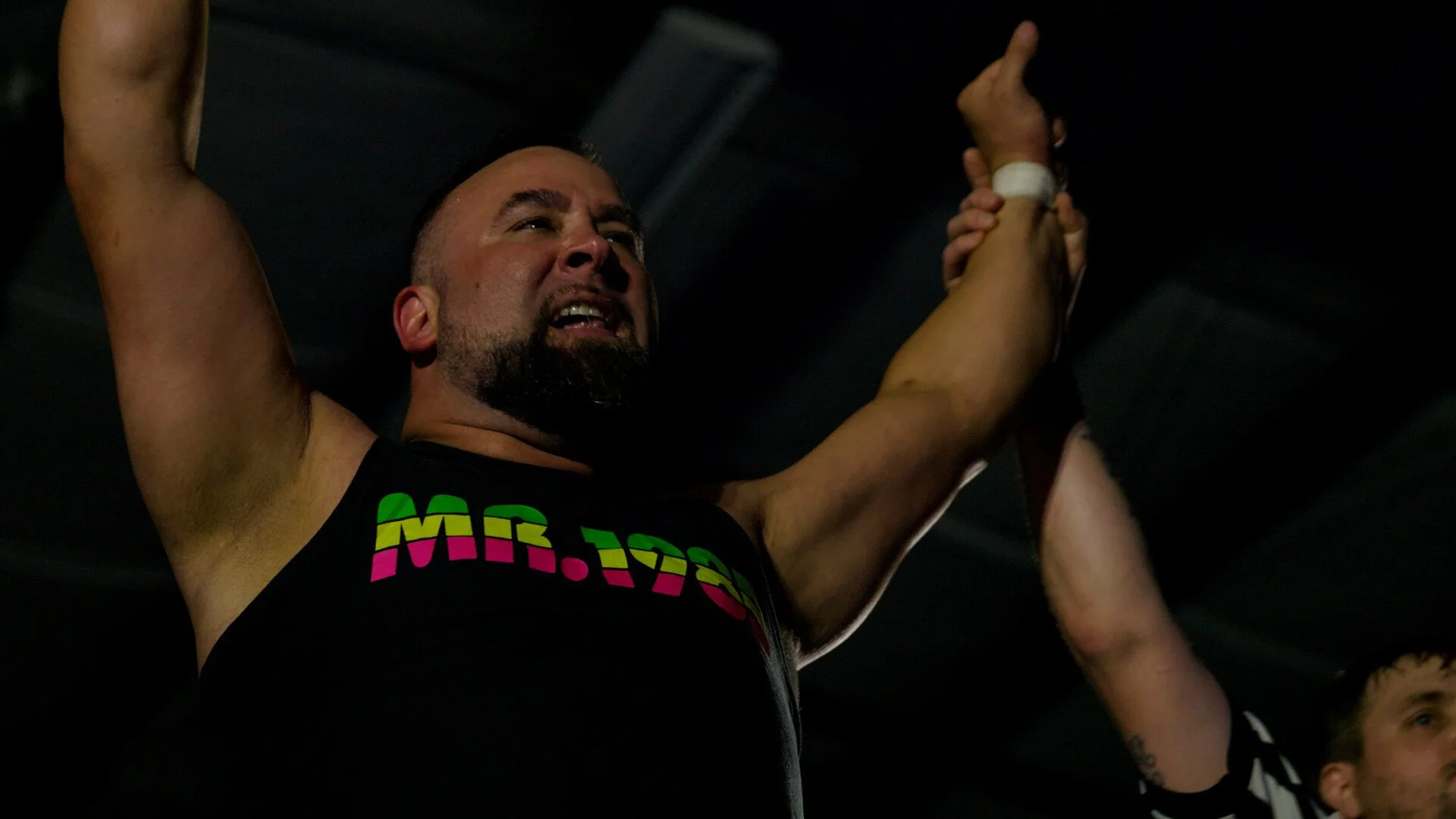 A still from the film "The Mayor of Rasslin'." Man celebrating with arms raised.