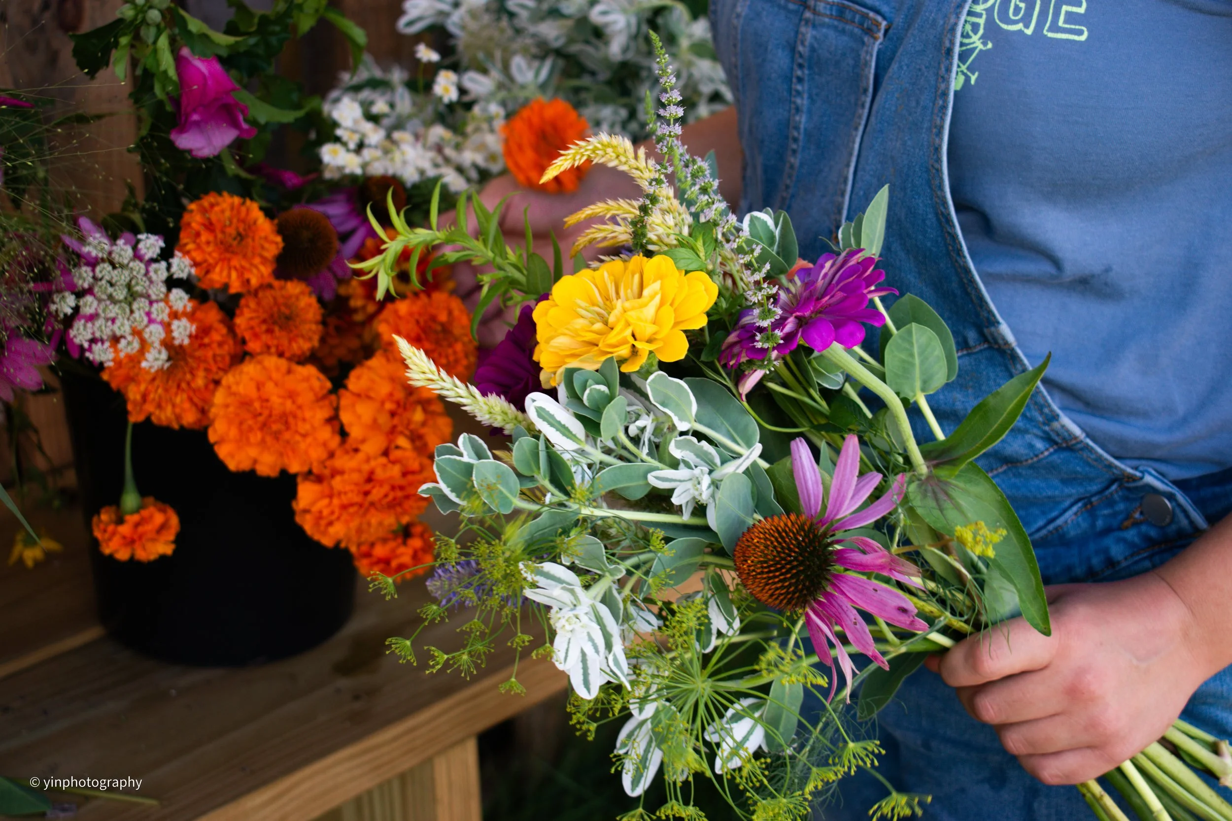 Making a bouquet with seasonally grown flowers at an Indianapolis Farm Stand