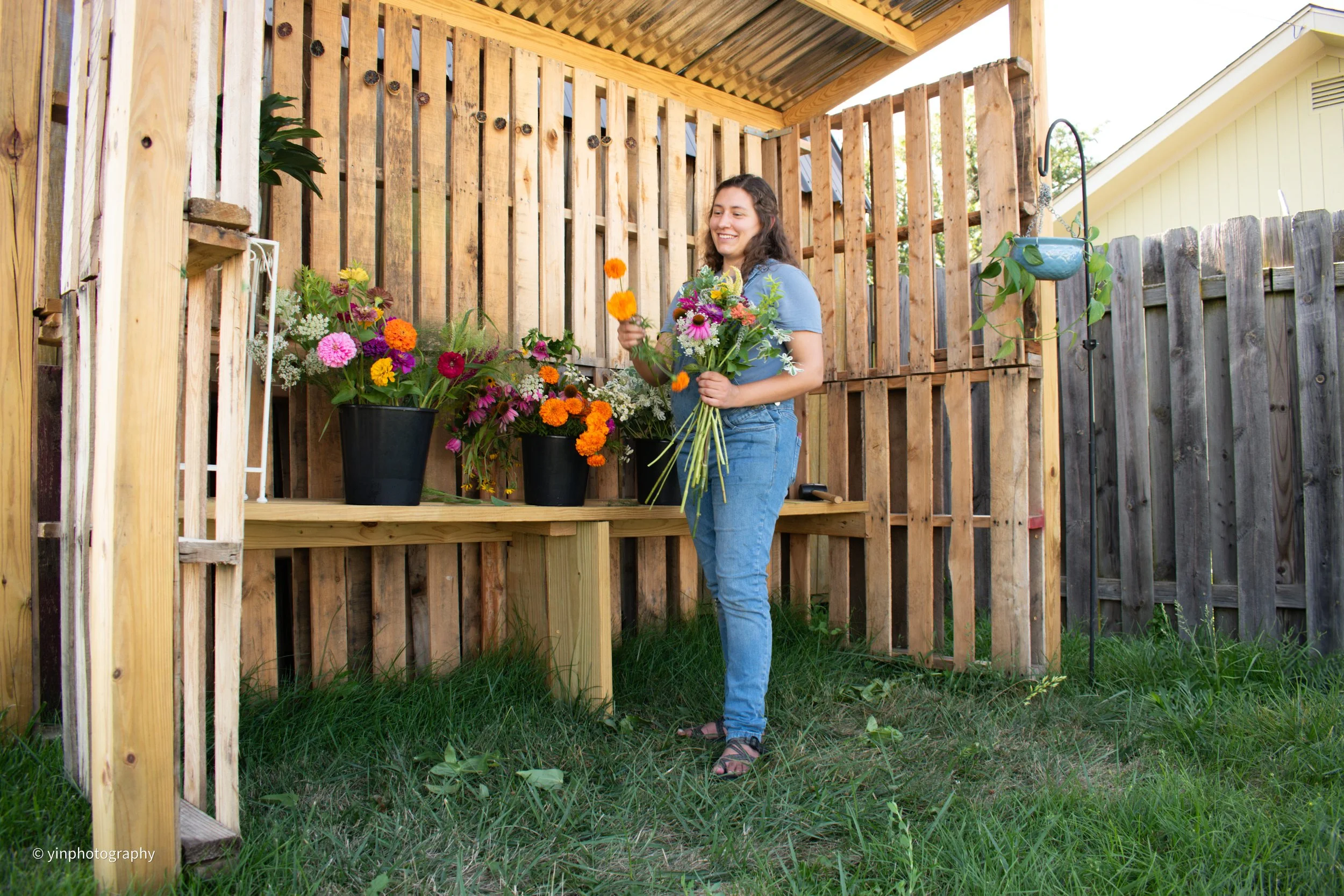 Flower farmer building a bouquet at her flower stand in Indianapolis