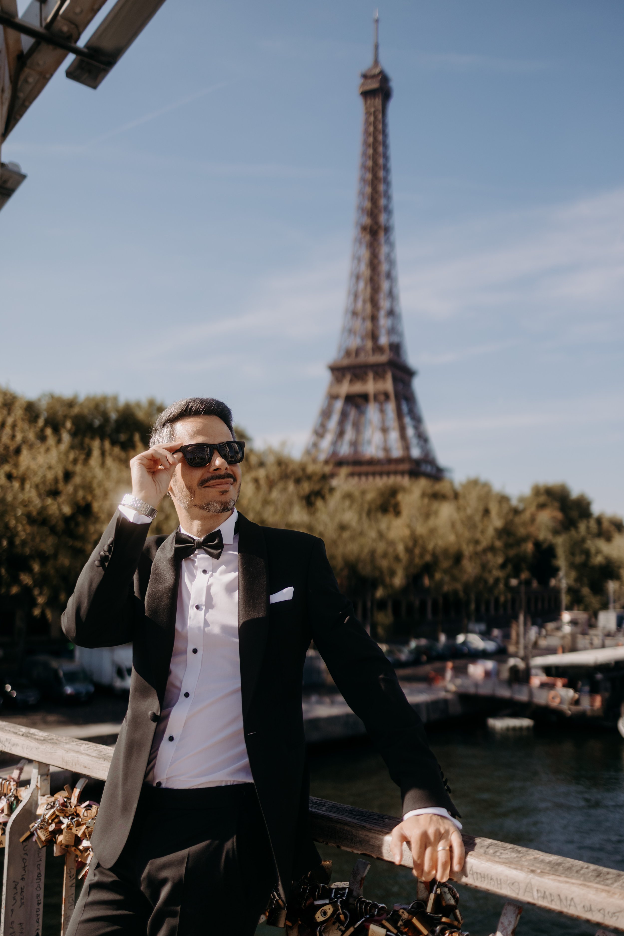 Marié cool et détendu, dans un smocking très classe, avec vue sur la Tour Eiffel. Destination Wedding. 