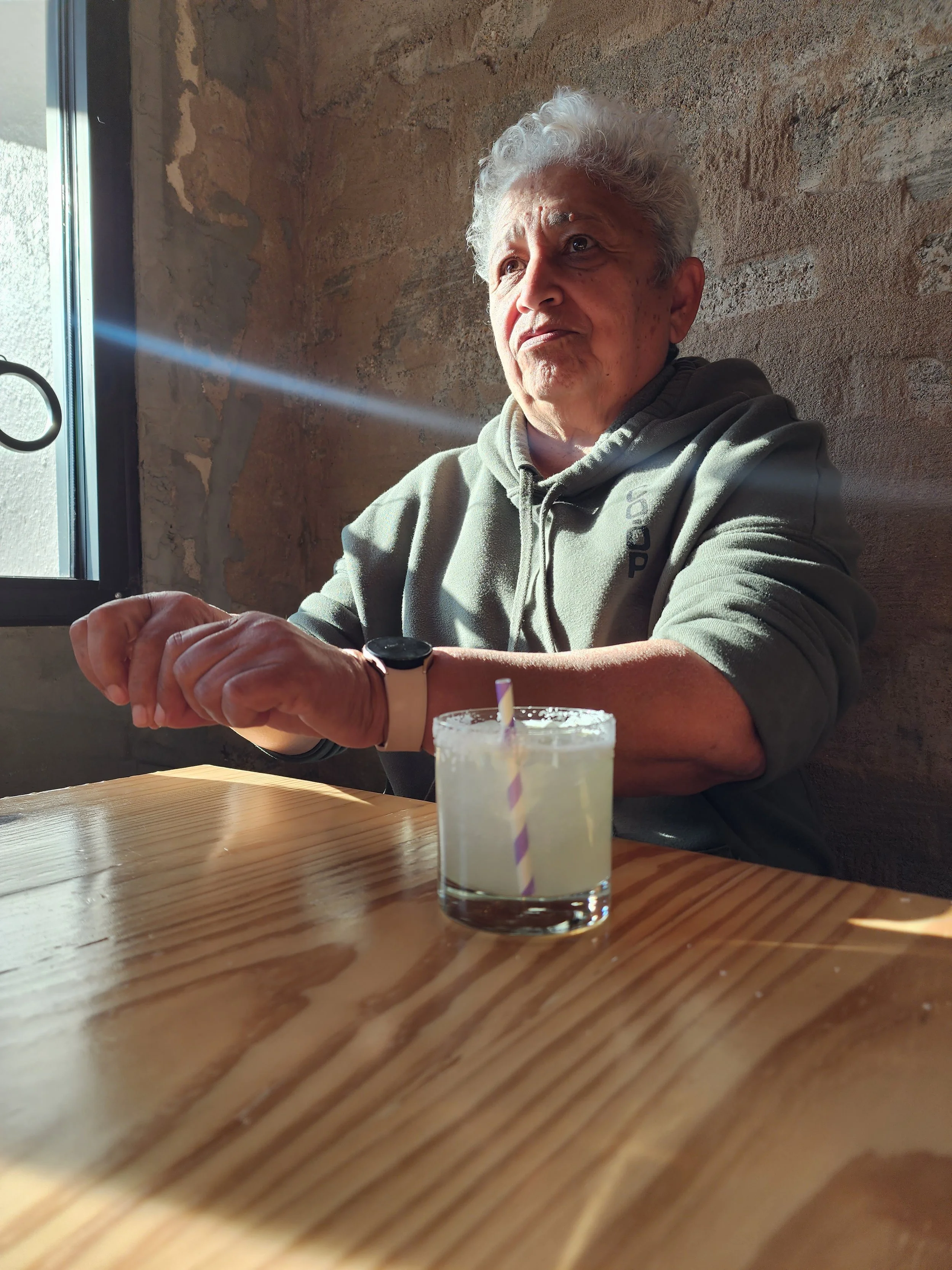 Carmen Medina sitting at a table being interviewed.