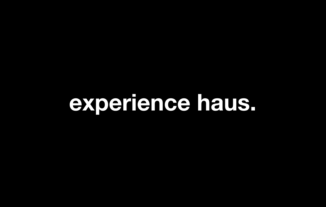 Black background with white text that reads "experience haus."