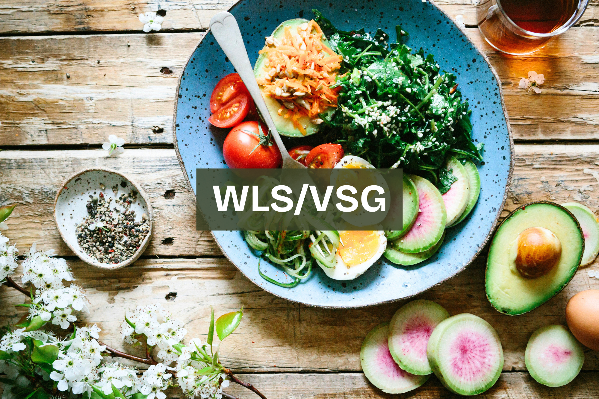 A colorful salad served on a blue plate, featuring sliced tomatoes, avocado, cucumber, shredded carrots, leafy greens, a soft-boiled egg, and sprinkled seeds. small portion high protein bariatric meal Nourix. bariatric friendly lean protein meal.