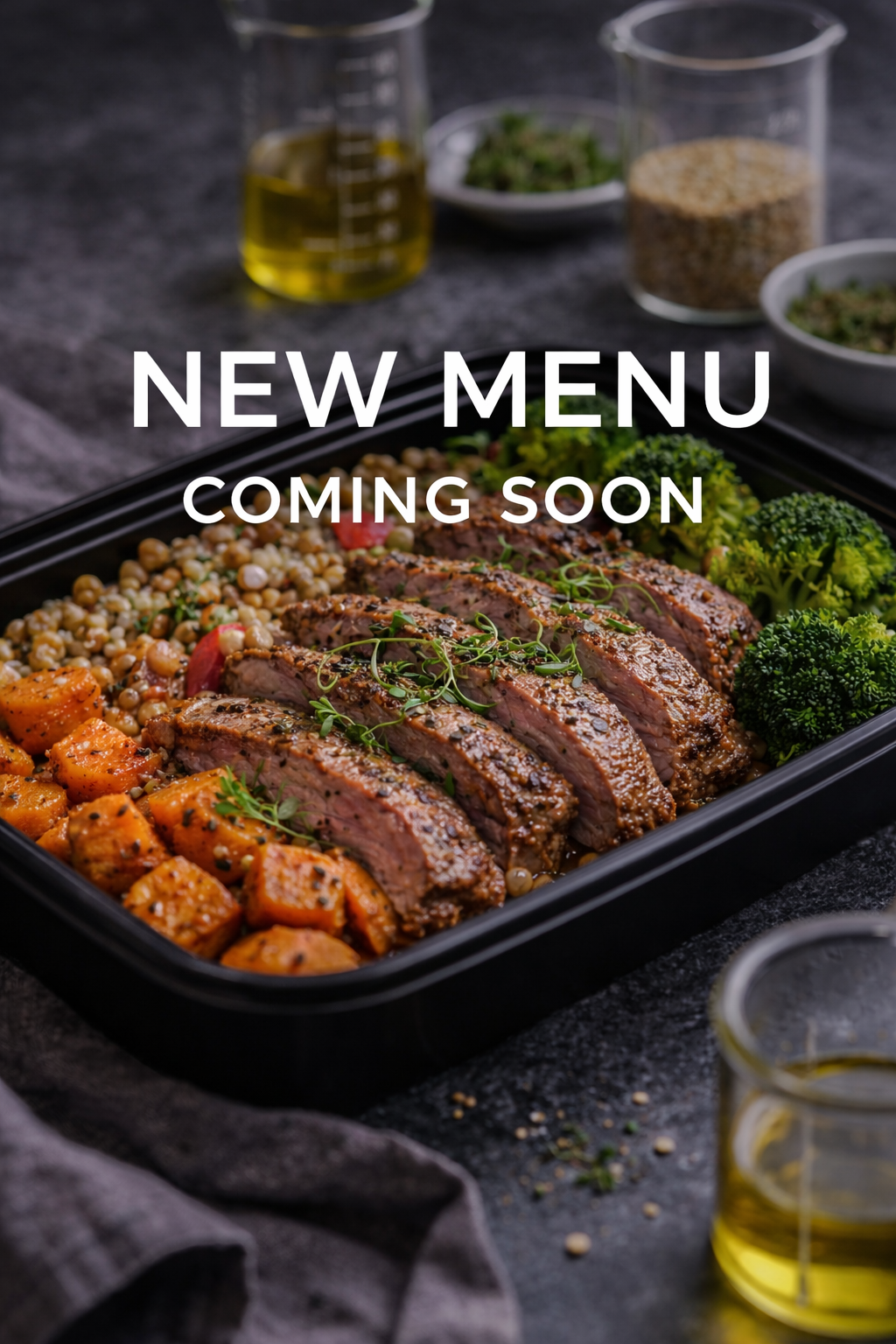 A black tray with sliced cooked meat garnished with herbs, roasted sweet potatoes seasoned with spices, couscous or grains, and fresh broccoli, on a dark surface with small bowls of herbs, spices, and olive oil in the background.