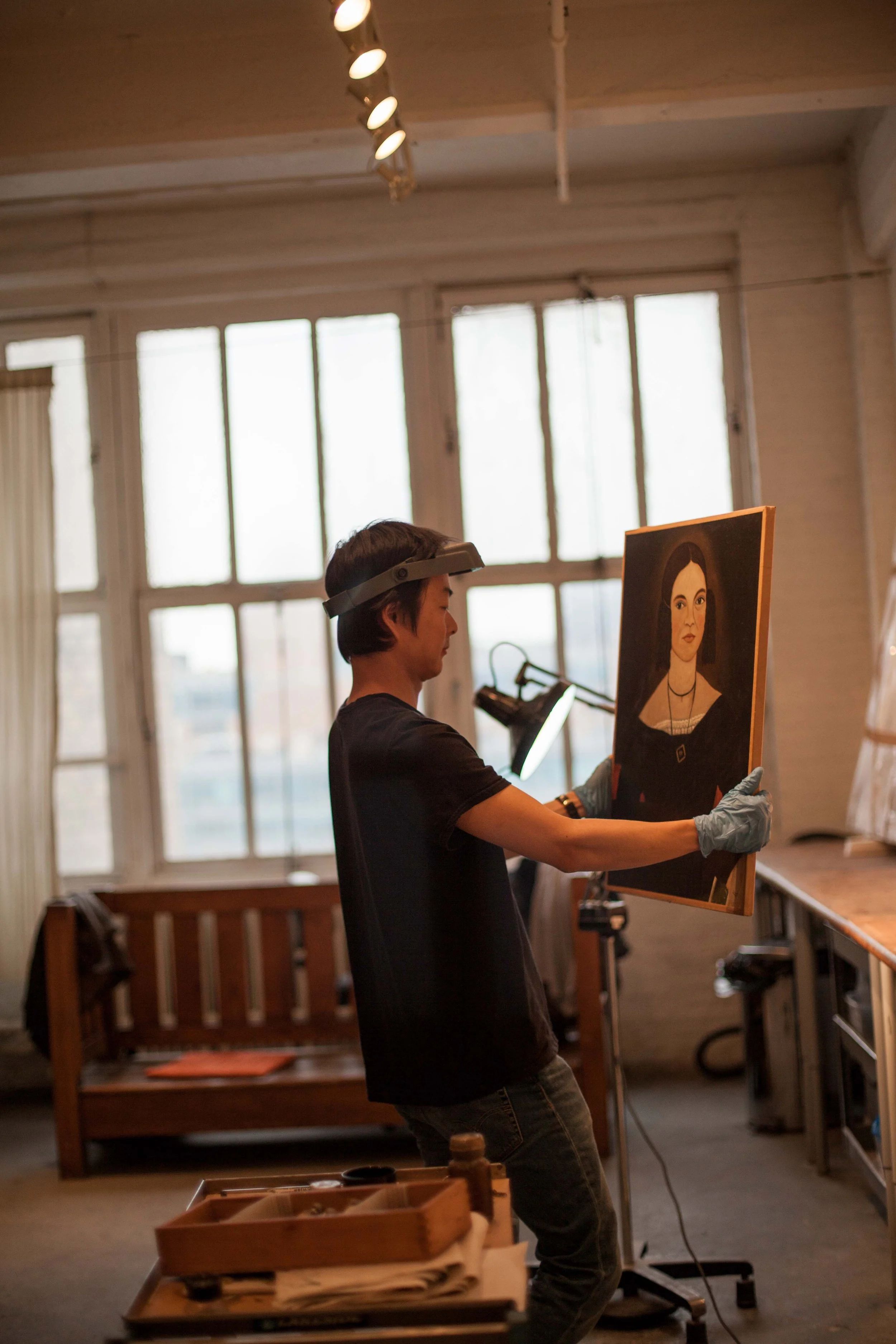 Art restore handling painting.