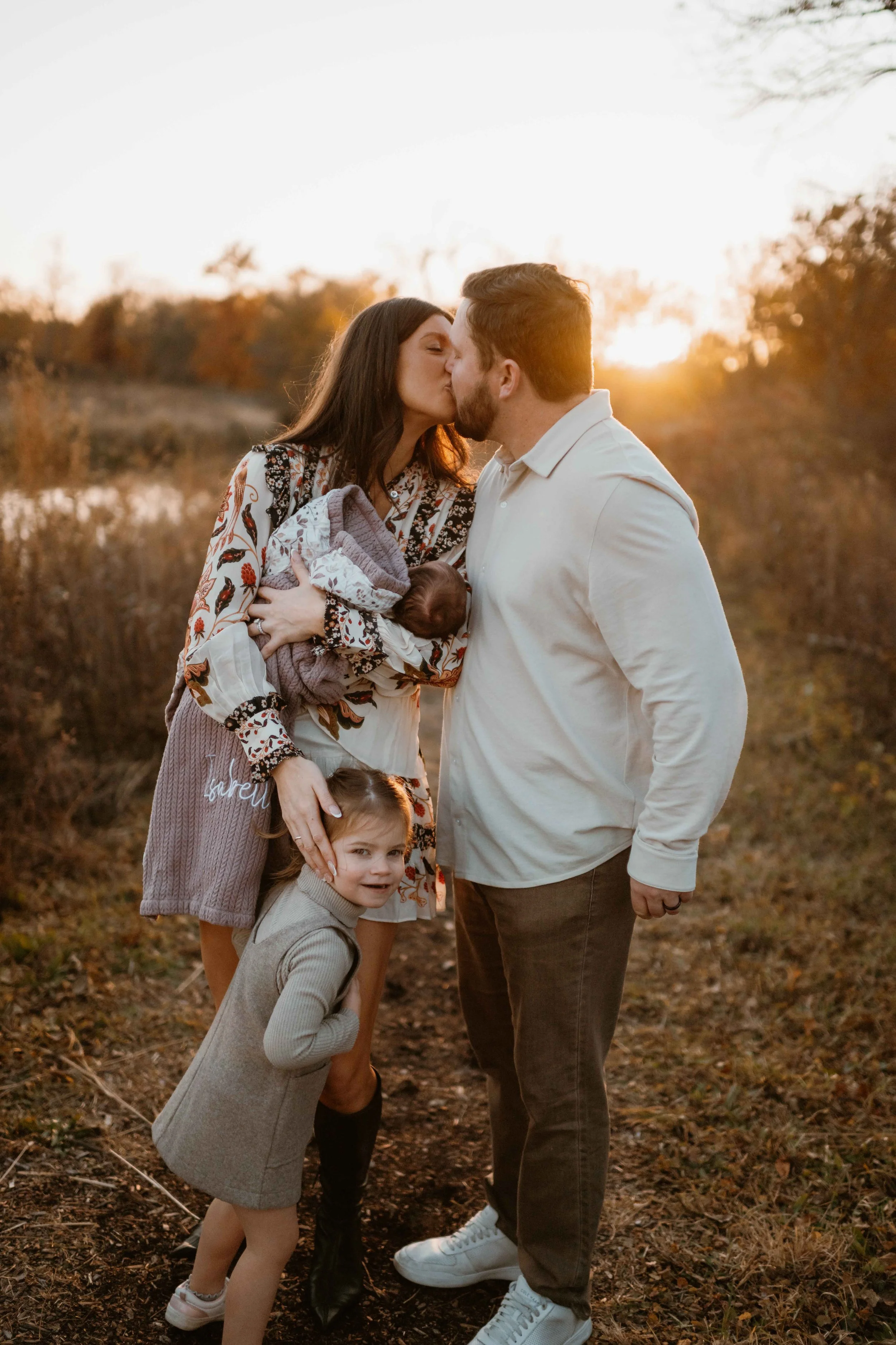 mom and dad kissing during family photos at Morton Arboretum Lisle IL  