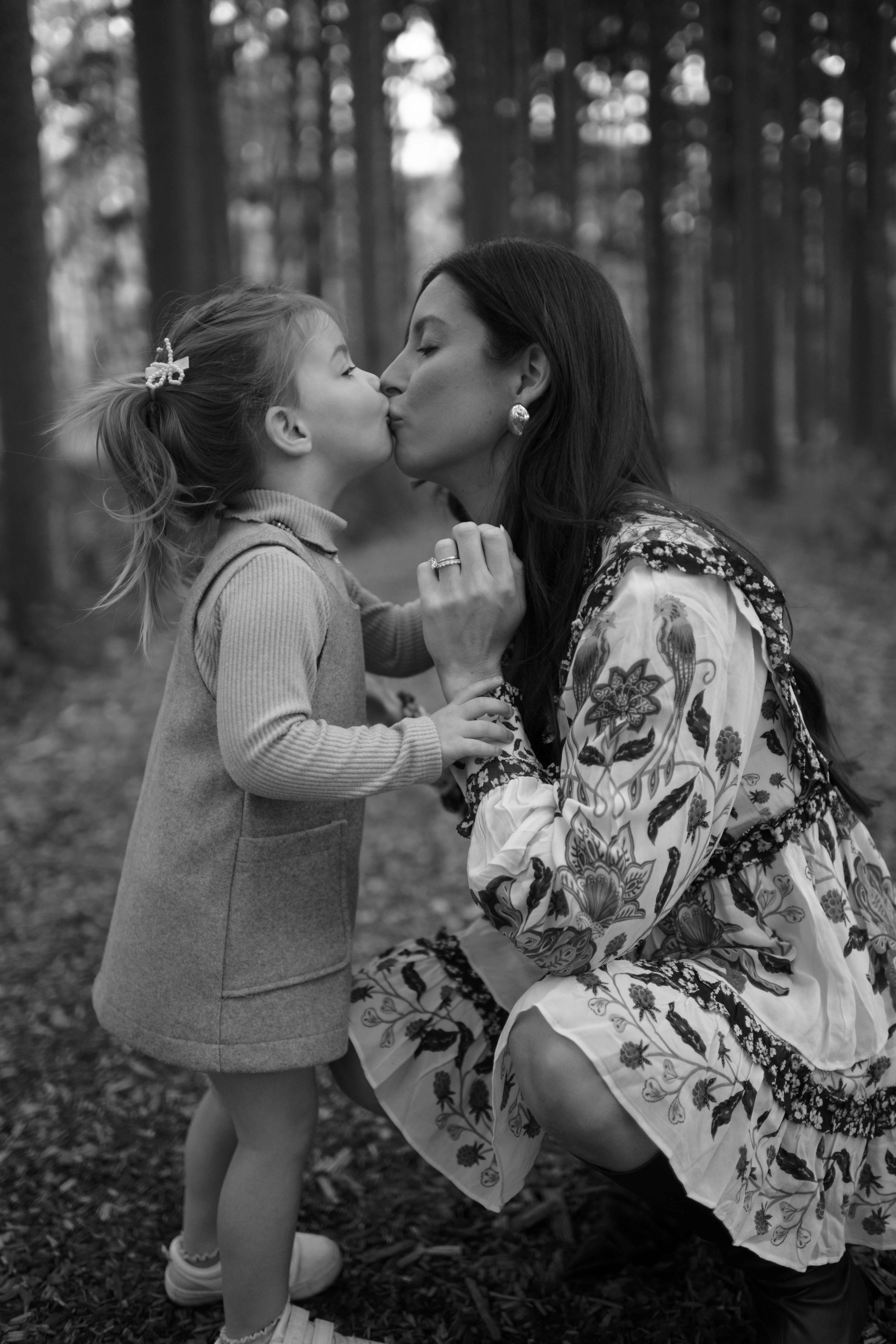 black and white mom and daughter kiss at Morton Arboretum Lisle IL 