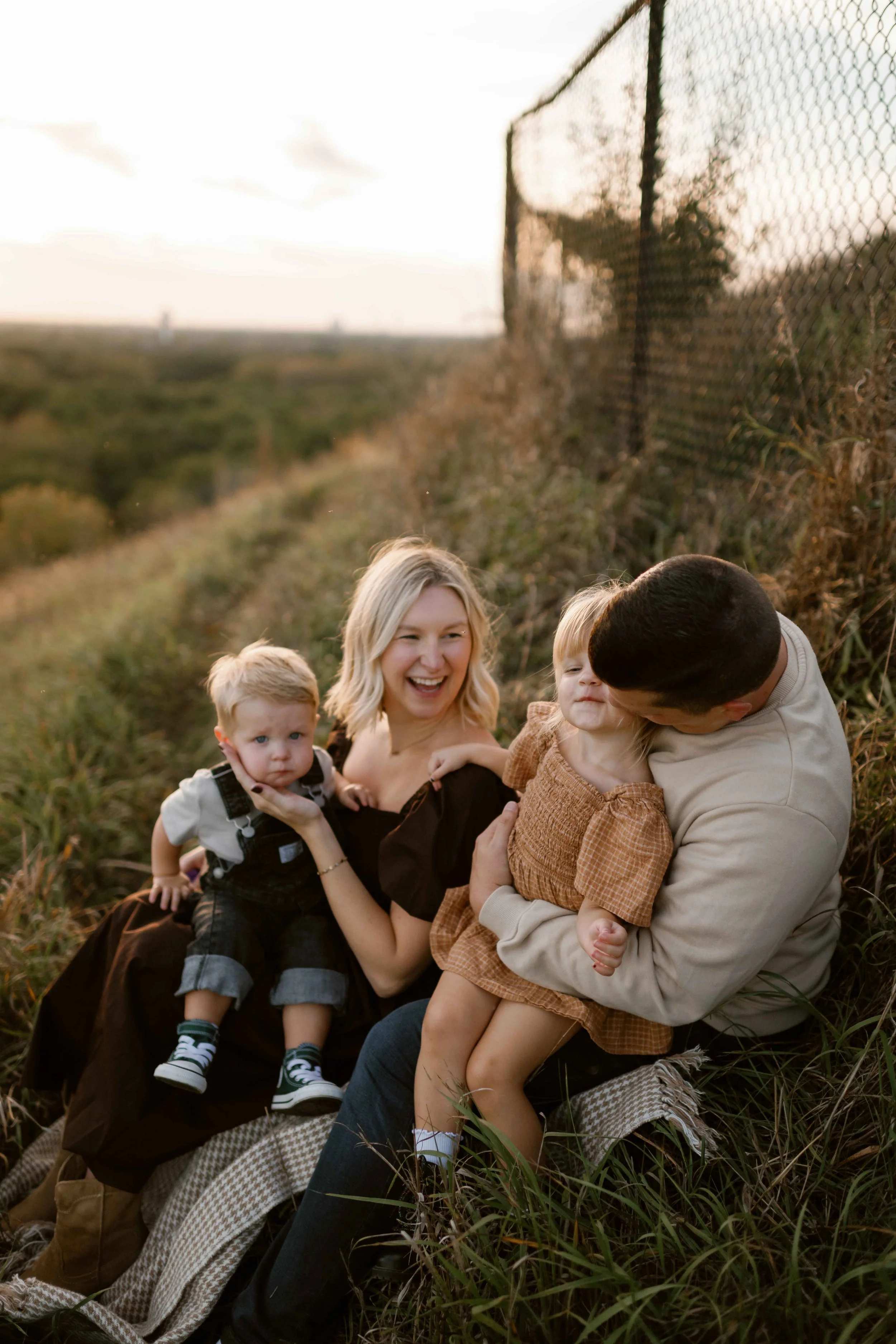 family snuggling at sunset on top of Blackwell Forest Preserve in Wheaton