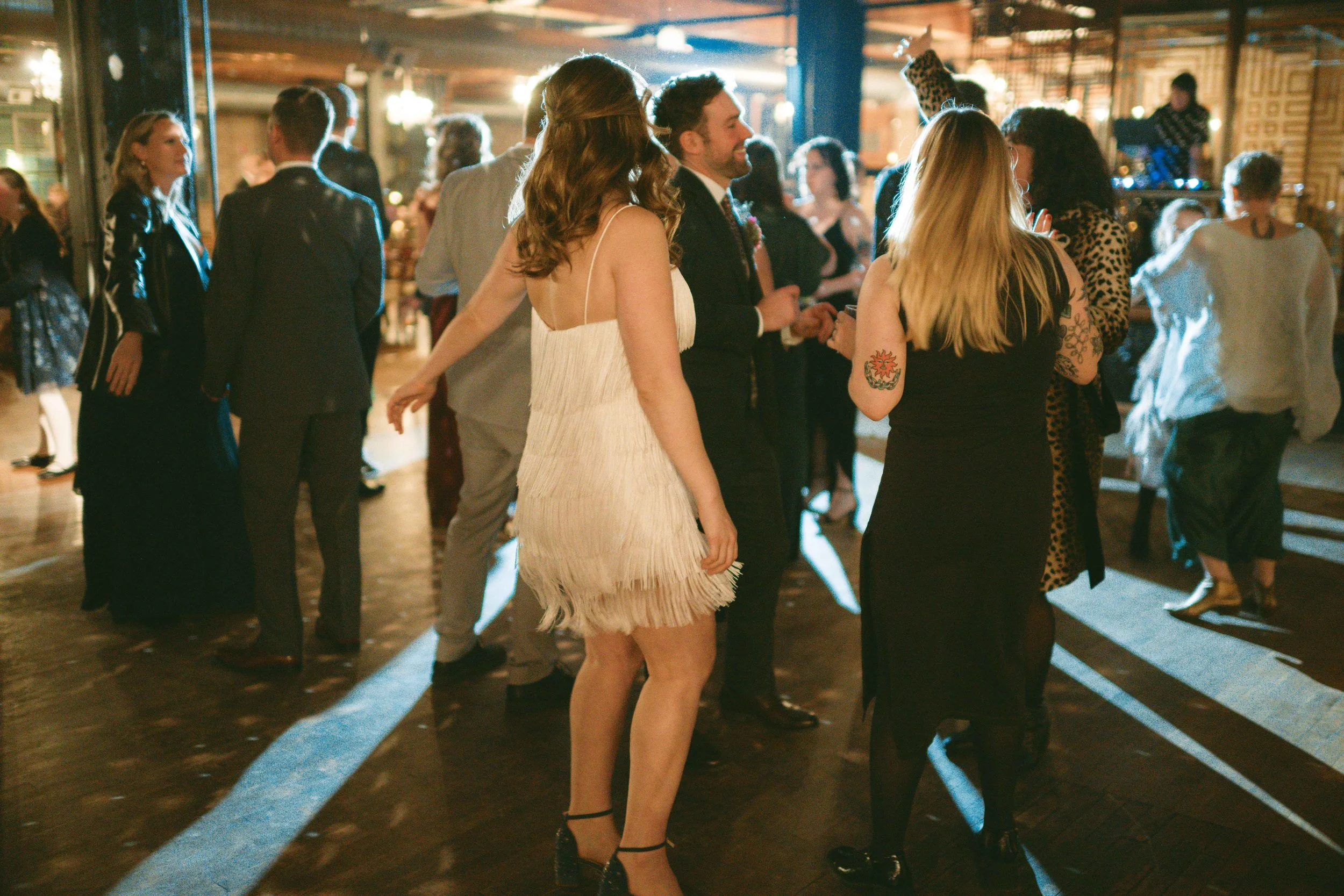 salvage one chicago wedding reception dancing bride with her dress change white fringe dress