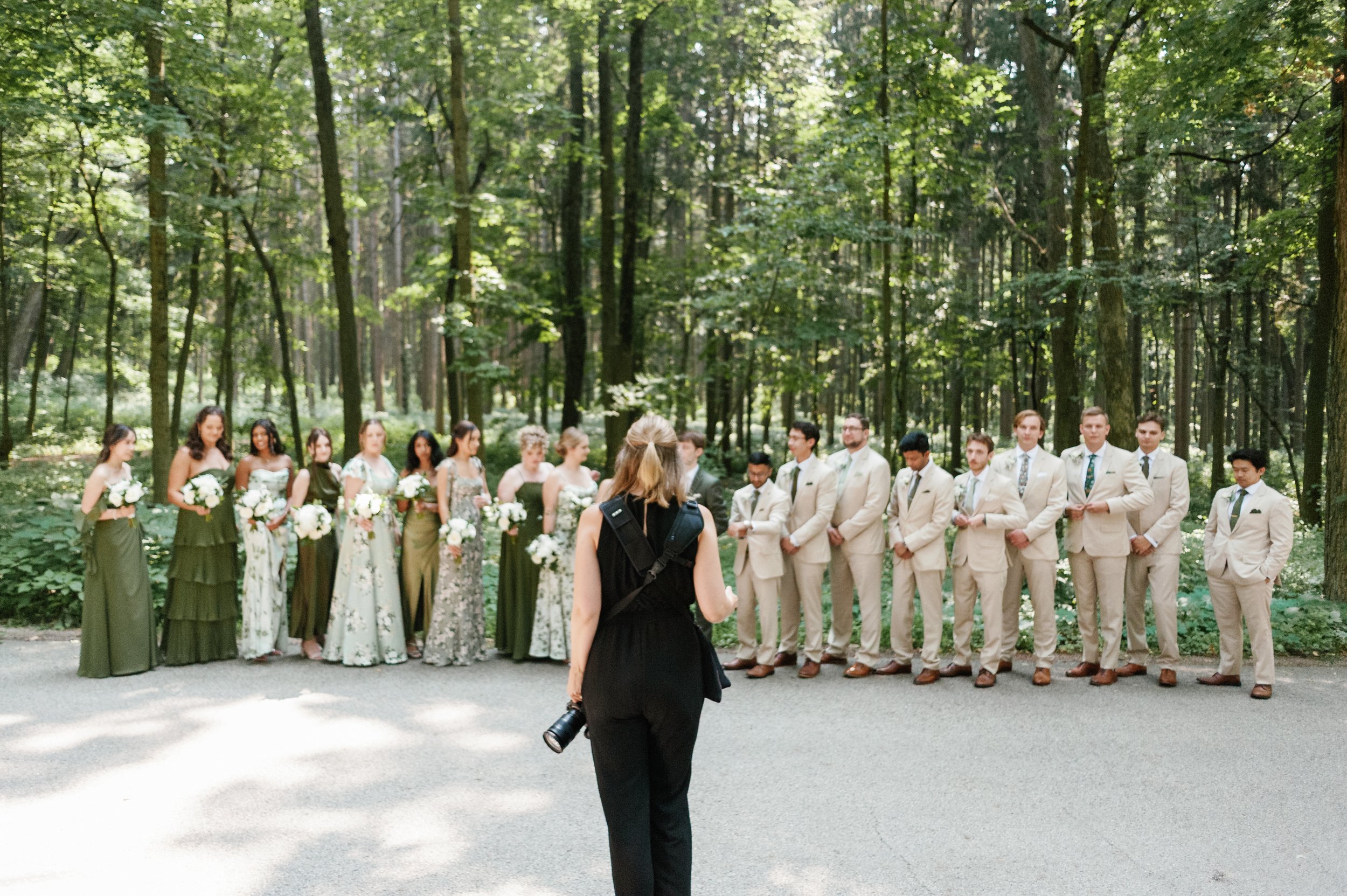 Photo of Kayla Walker behind the scenes at the Morton Arboretum photographing a wedding