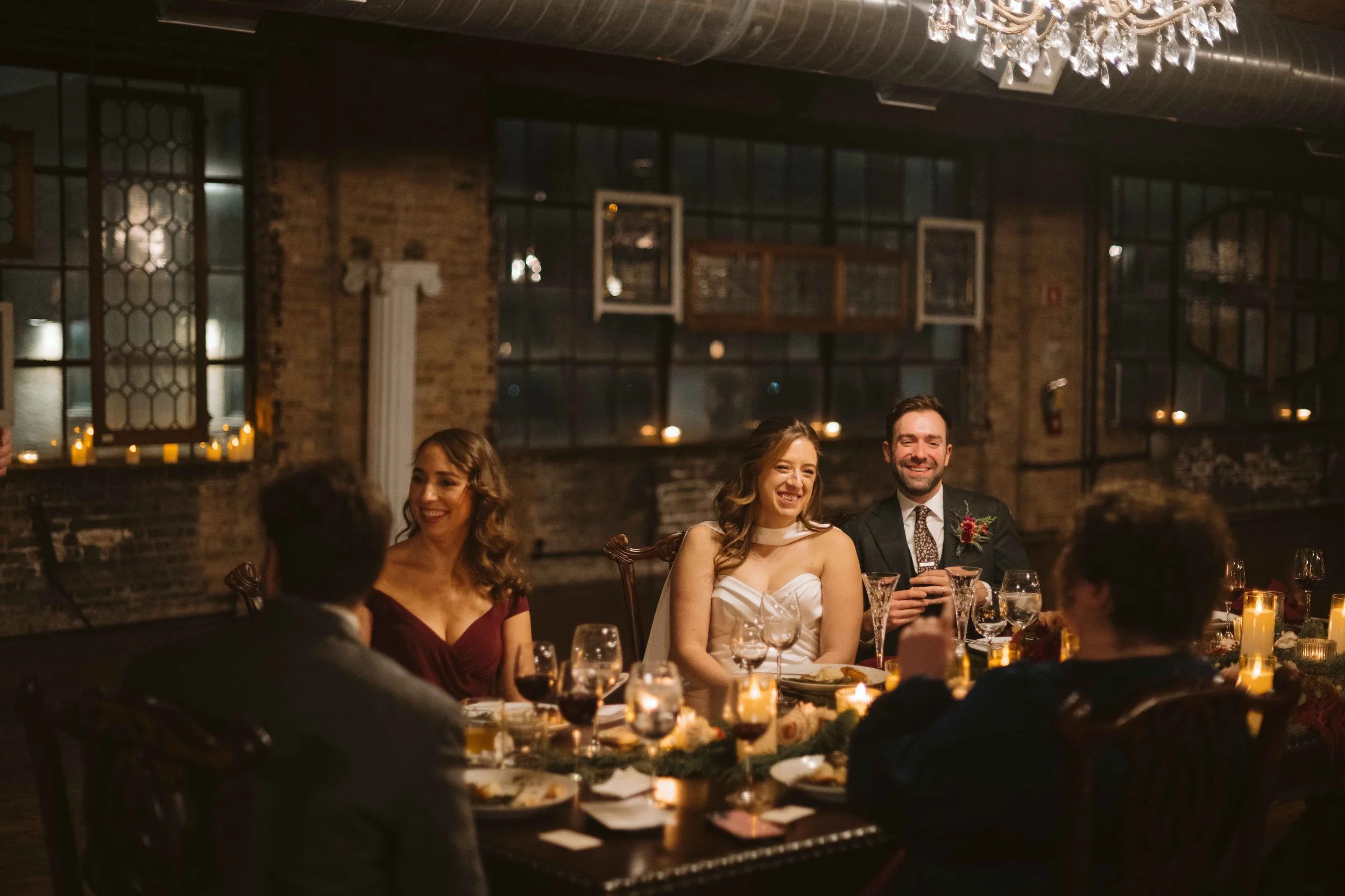 salvage one chicago wedding reception candid shot of bride and groom at head table