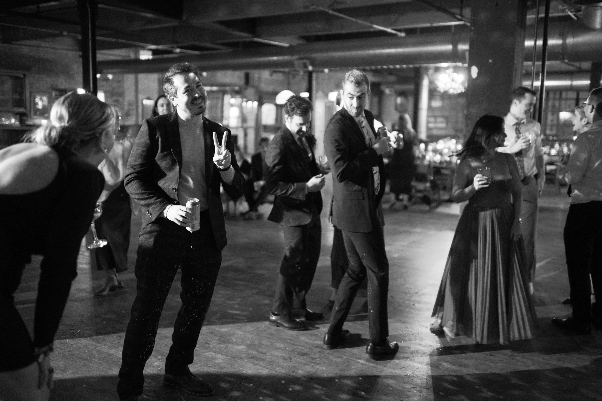 salvage one chicago wedding reception guest gives peace sign