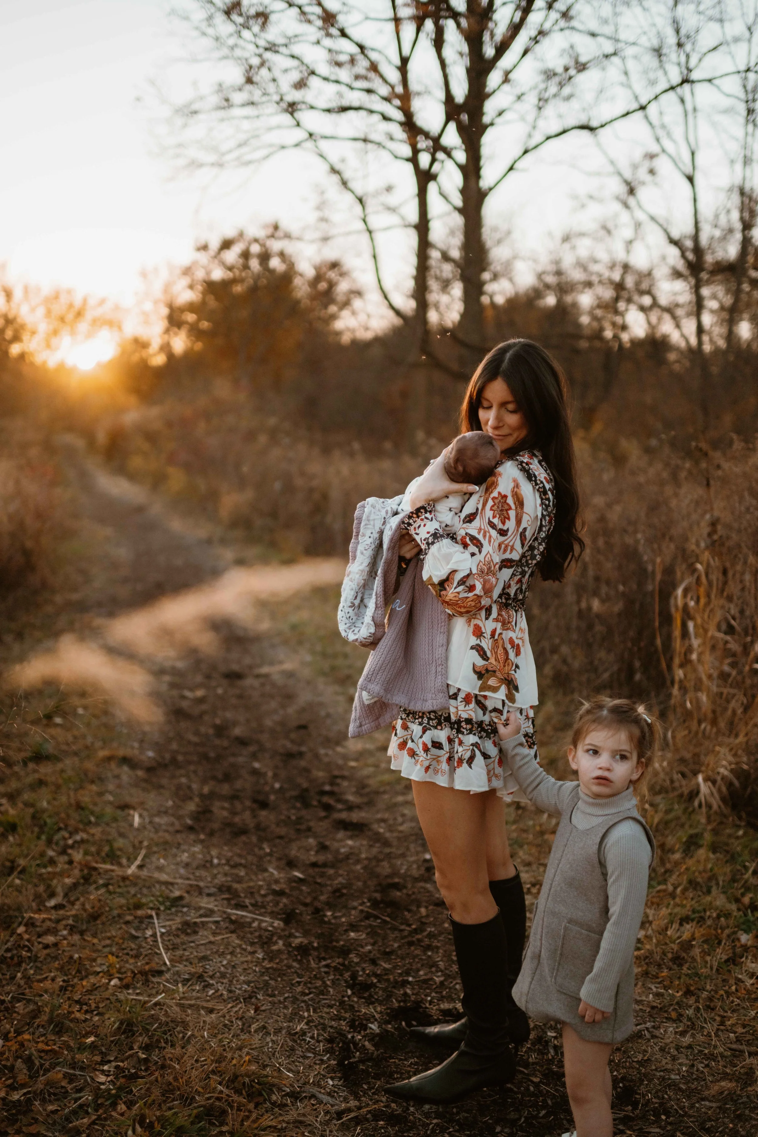 sunset photo of daughter tugging in moms dress at the Morton Arboretum Lisle IL 