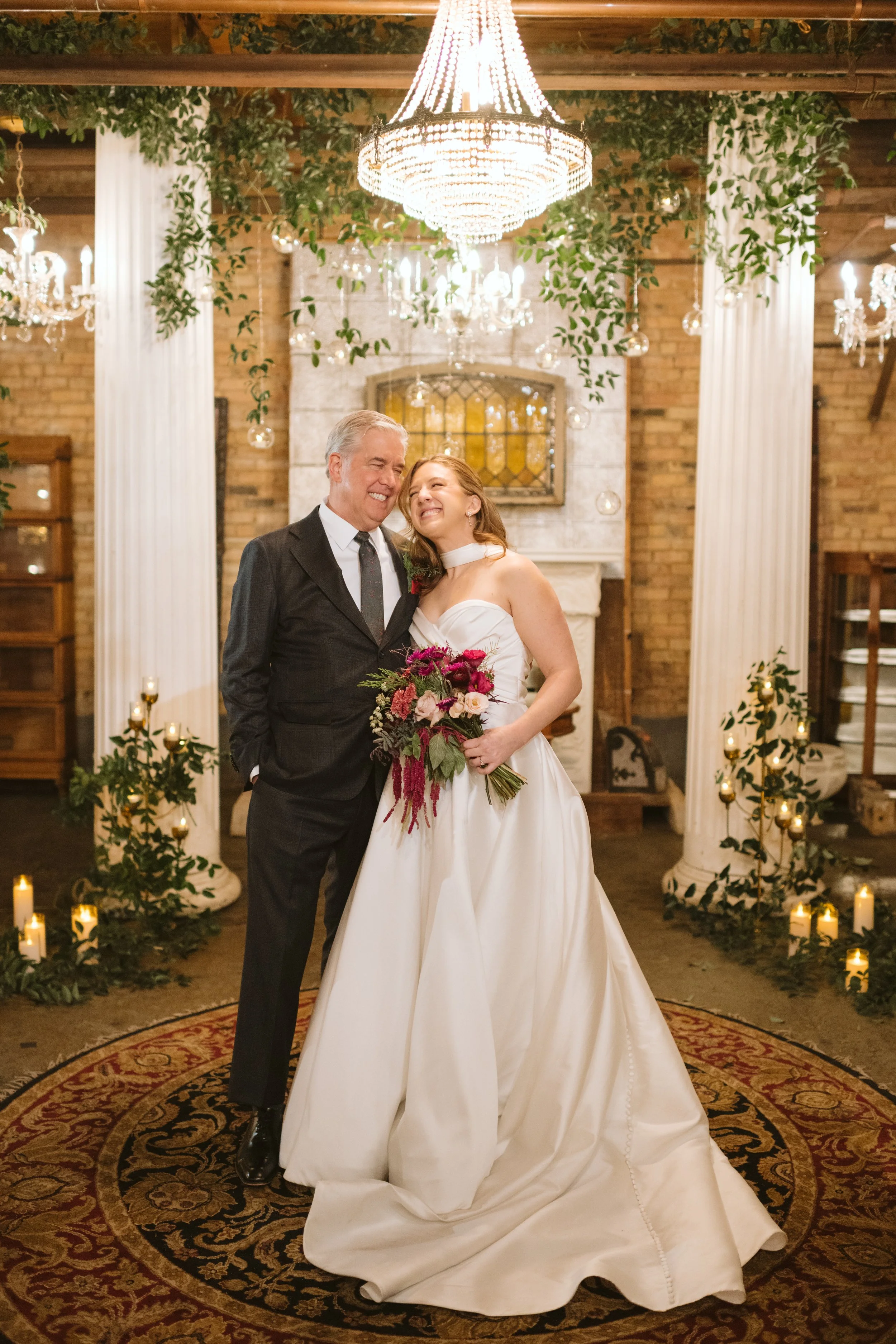 Candid photo of bride and her dad during family photos at Salvage One in Chicago Illinois