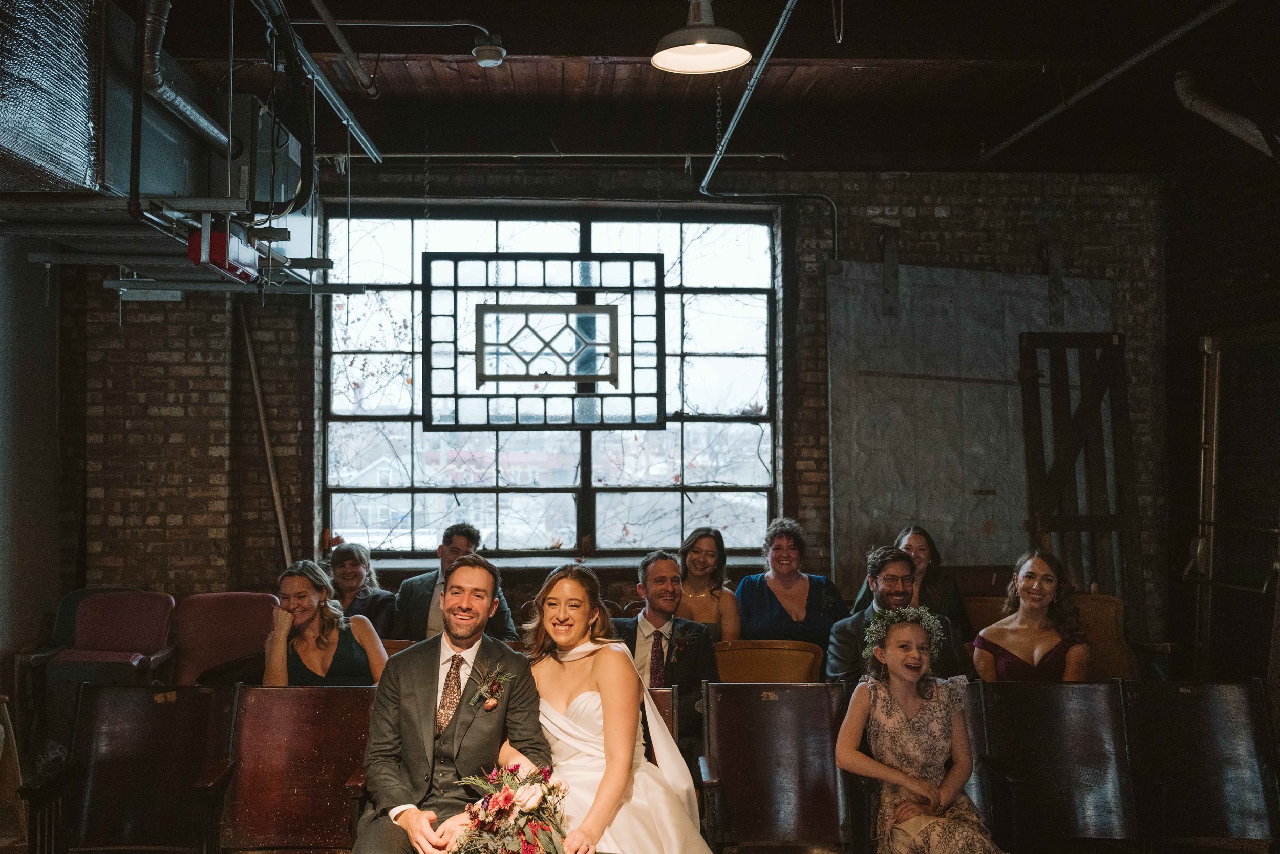Bridal party in theatre seats at Salvage One in Chicago IL