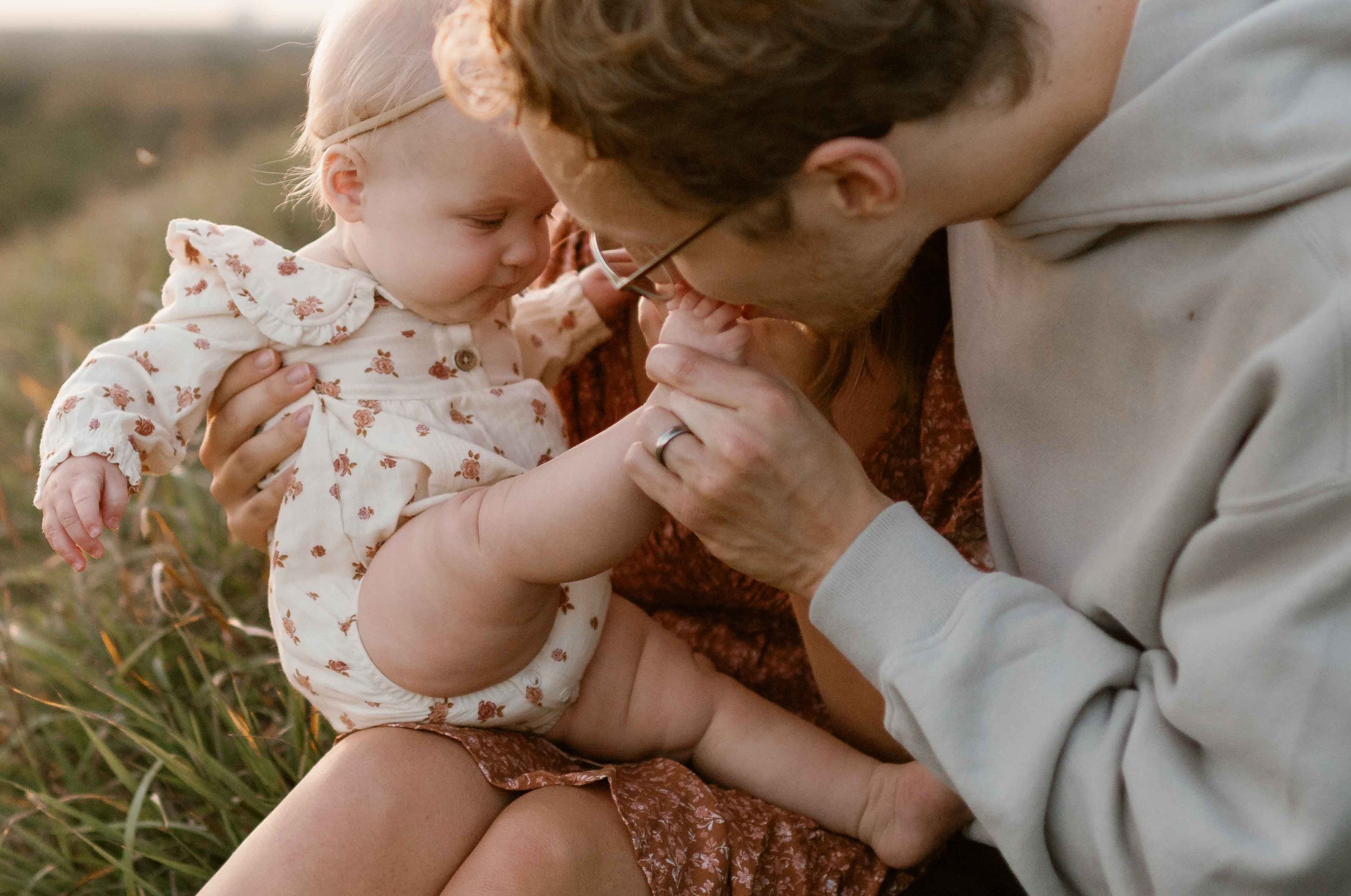 Dad kissing toes of baby at Blackwell Forest Preserve in Illinois