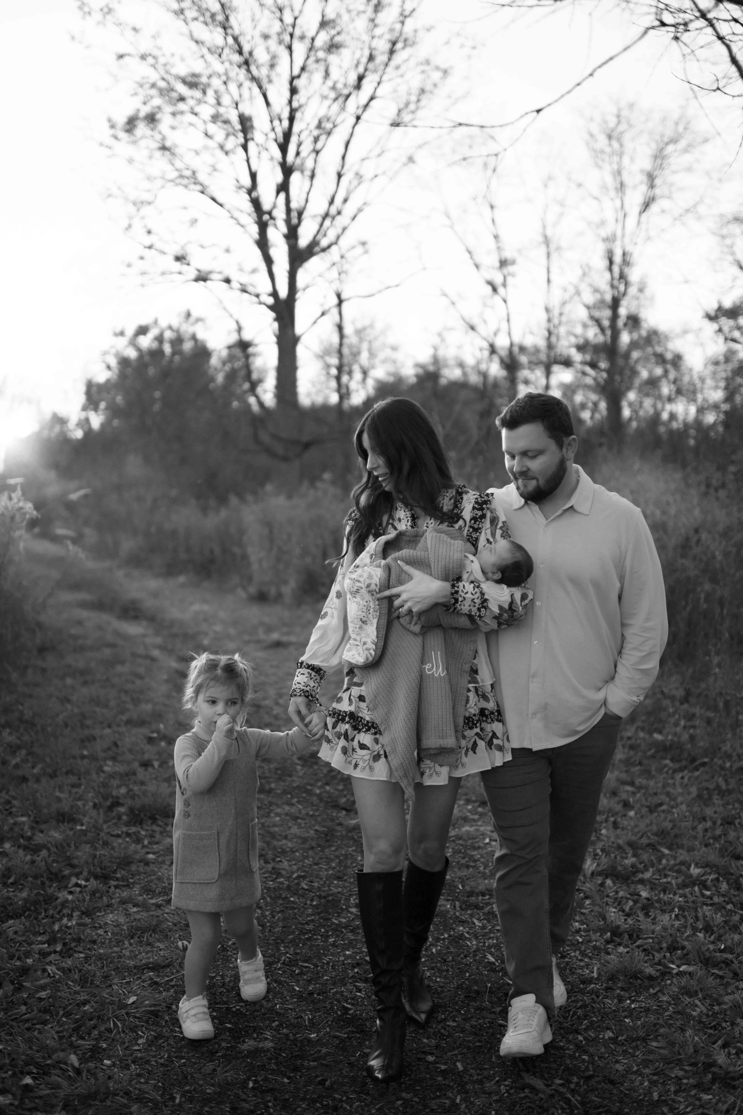 black and white photo family of four toddler sucking her thumb at the Morton Arboretum Lisle IL 
