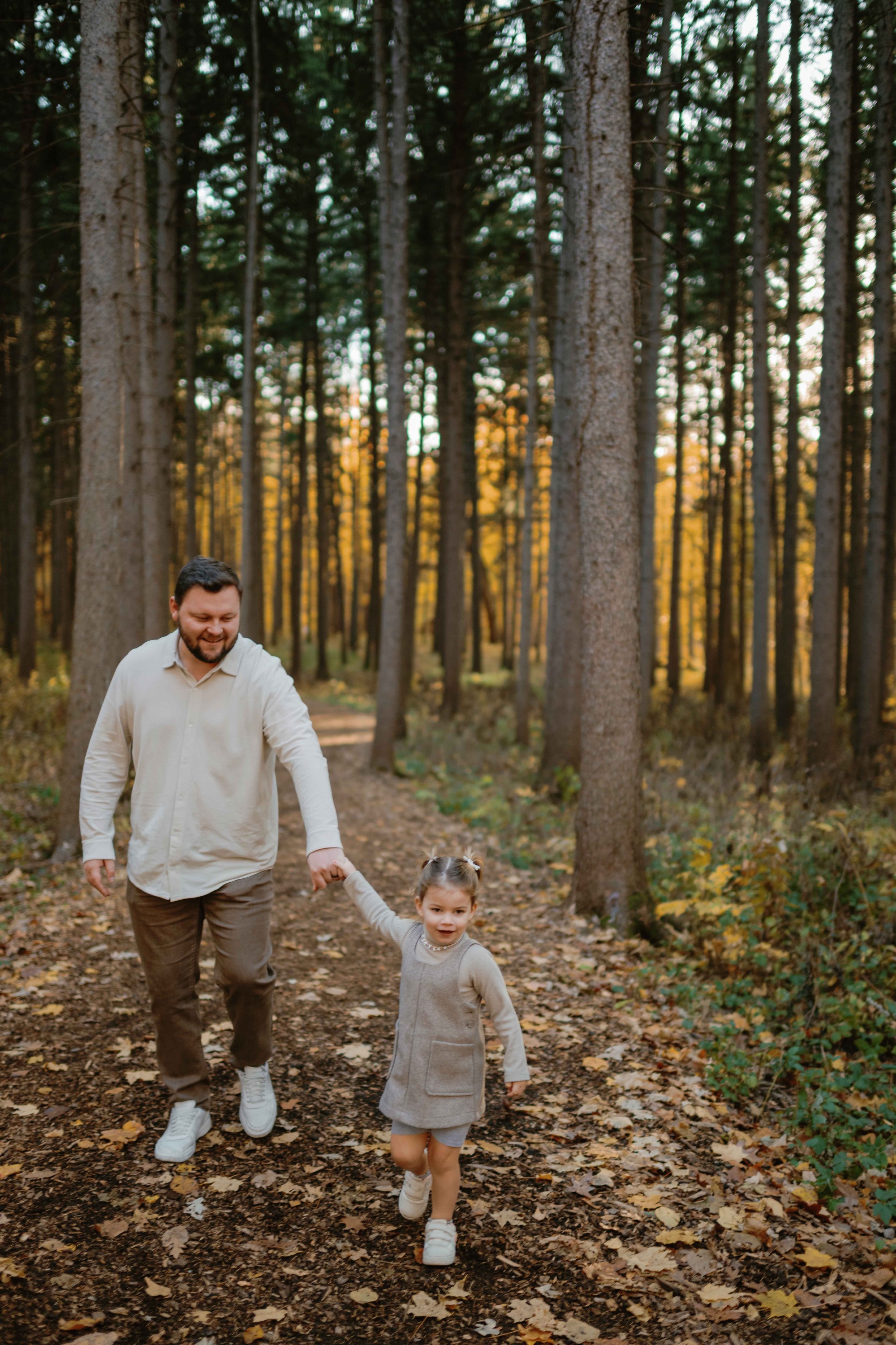 Toddler holding dad's hand at Morton Arboretum Lisle IL 