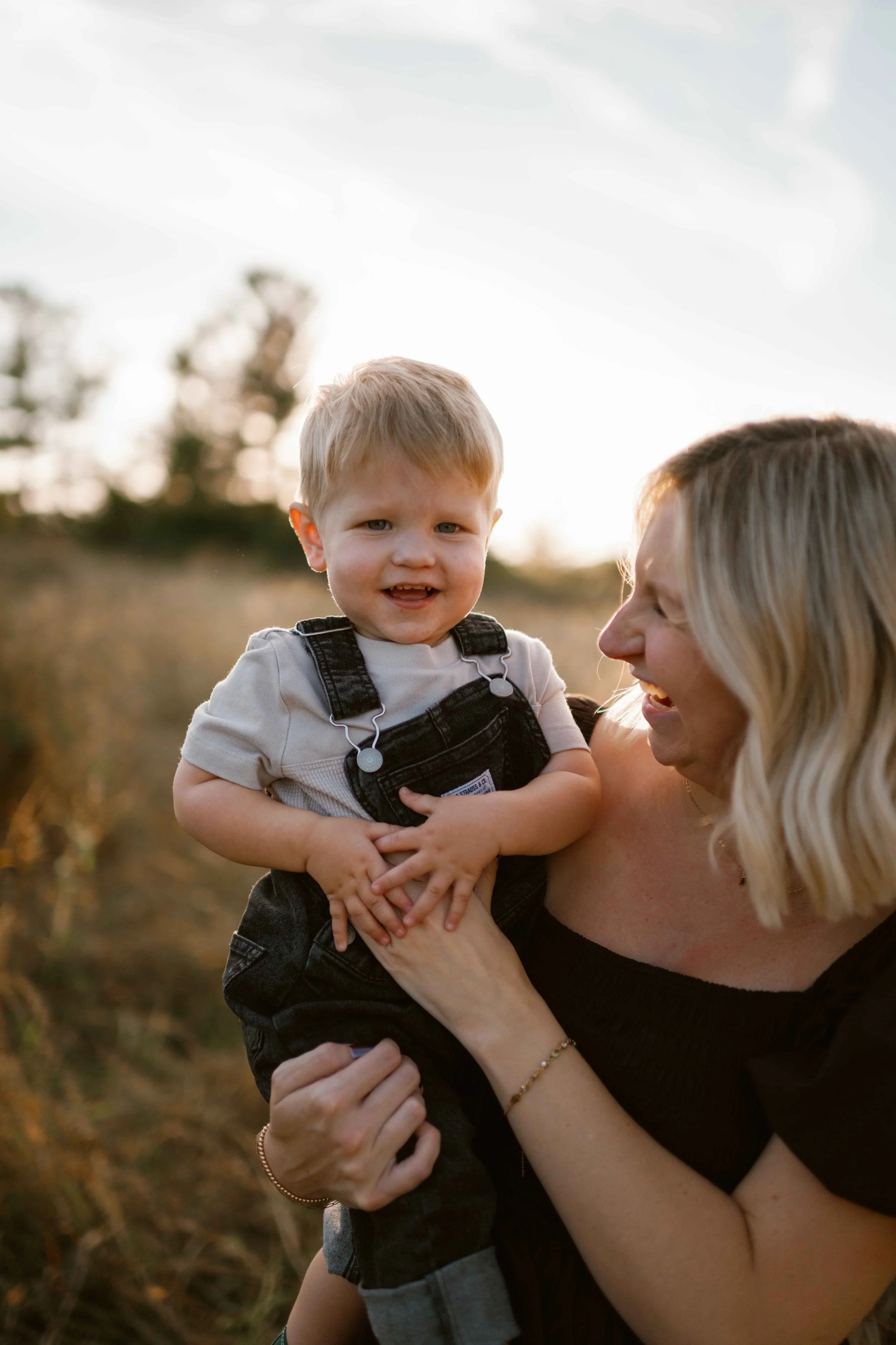 mom tickling son at sunset at Blackwell Forest Preserve Wheaton 
