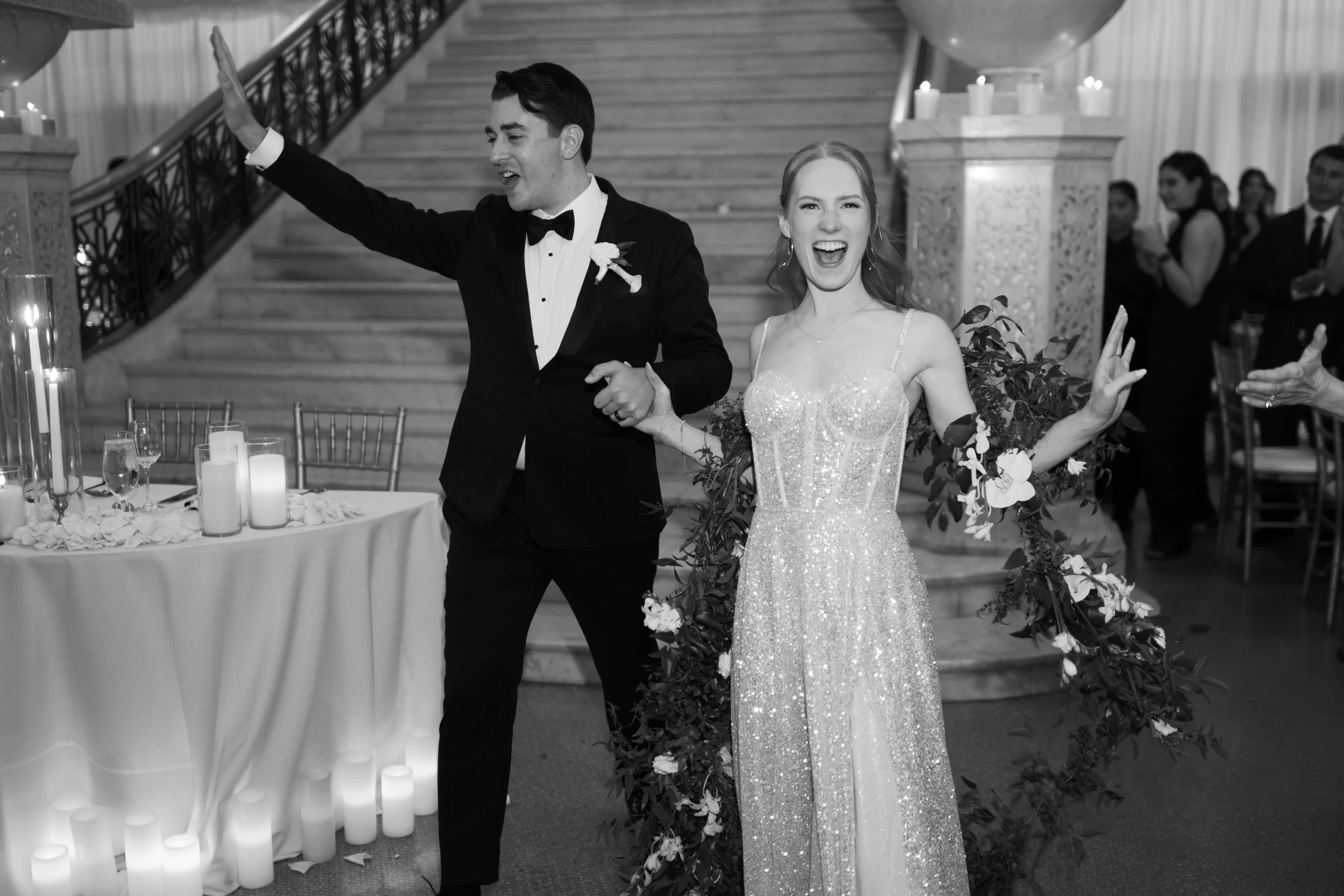 Black and white photo of bride and groom walking into their reception at The Rookery in Chicago Illinois
