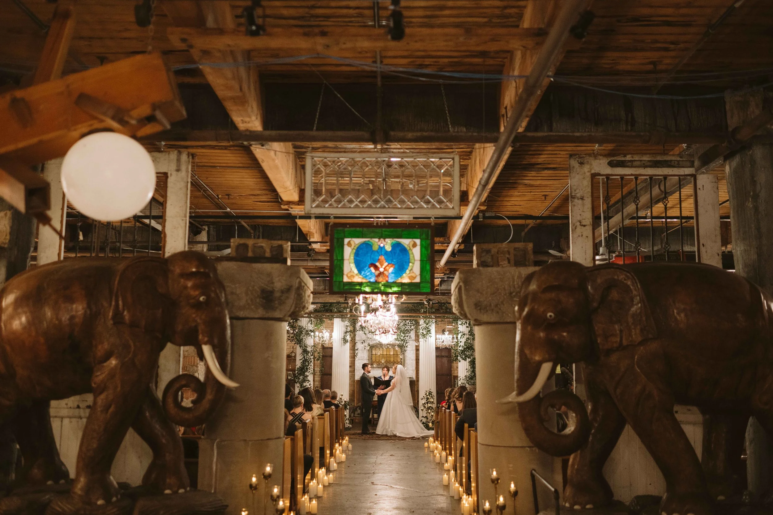 wide shot of Salvage One Chicago IL wedding ceremony with elephant statutes