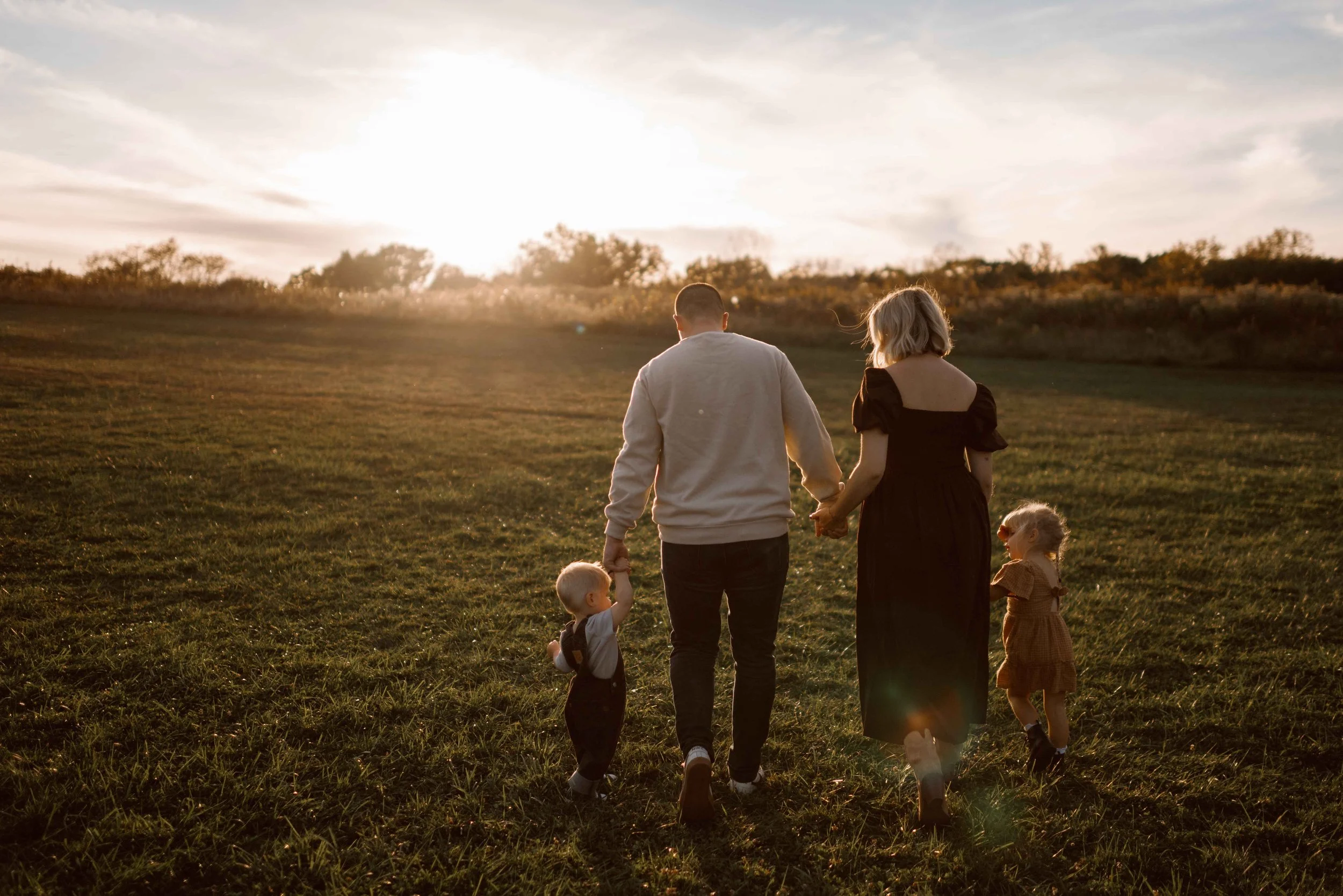 family of four walking at sunset at Blackwell Forest Preserve in Wheaton 