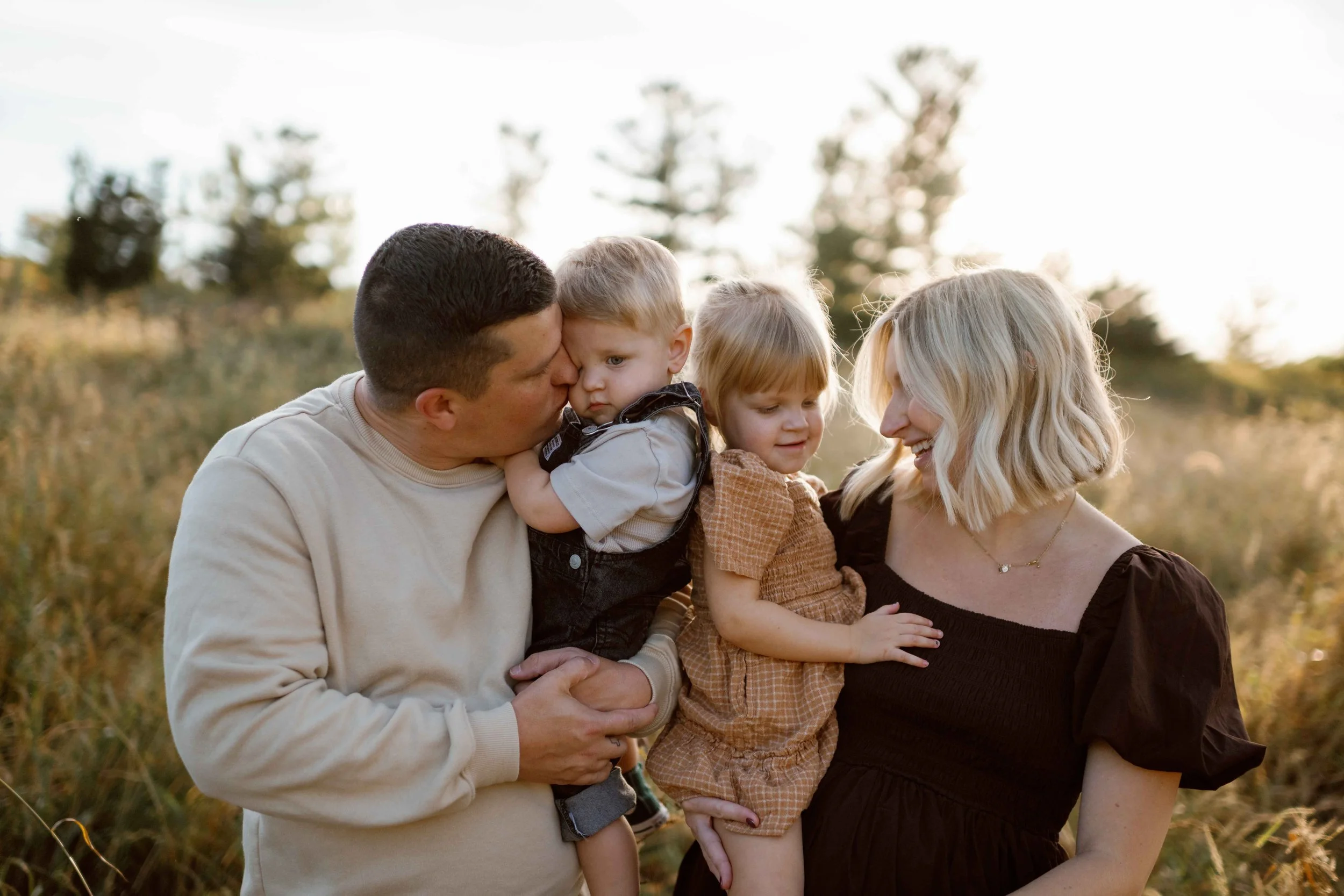 Blackwell Forest Preserve Wheaton  mom and dad kissing their kids in family photo